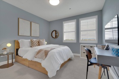 Comfortable Guest Bedroom!  Relax in this bright room featuring a comfy Queen bed with chic bedding. Enjoy the natural light from two large windows and make use of the dedicated workspace with a desk,perfect for remote work or study. 

