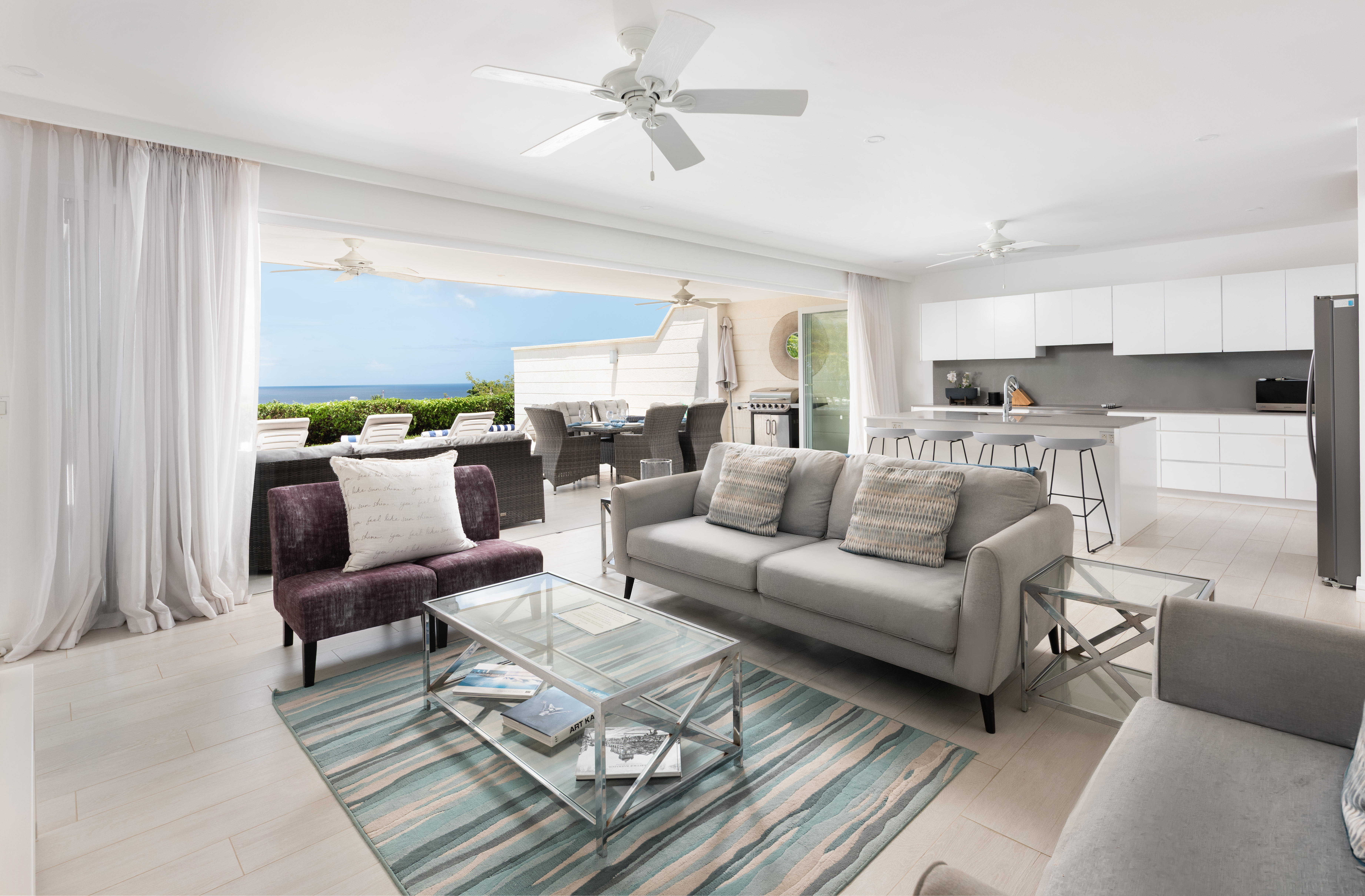 Bright open-plan living with modern kitchen and stunning ocean-view terrace