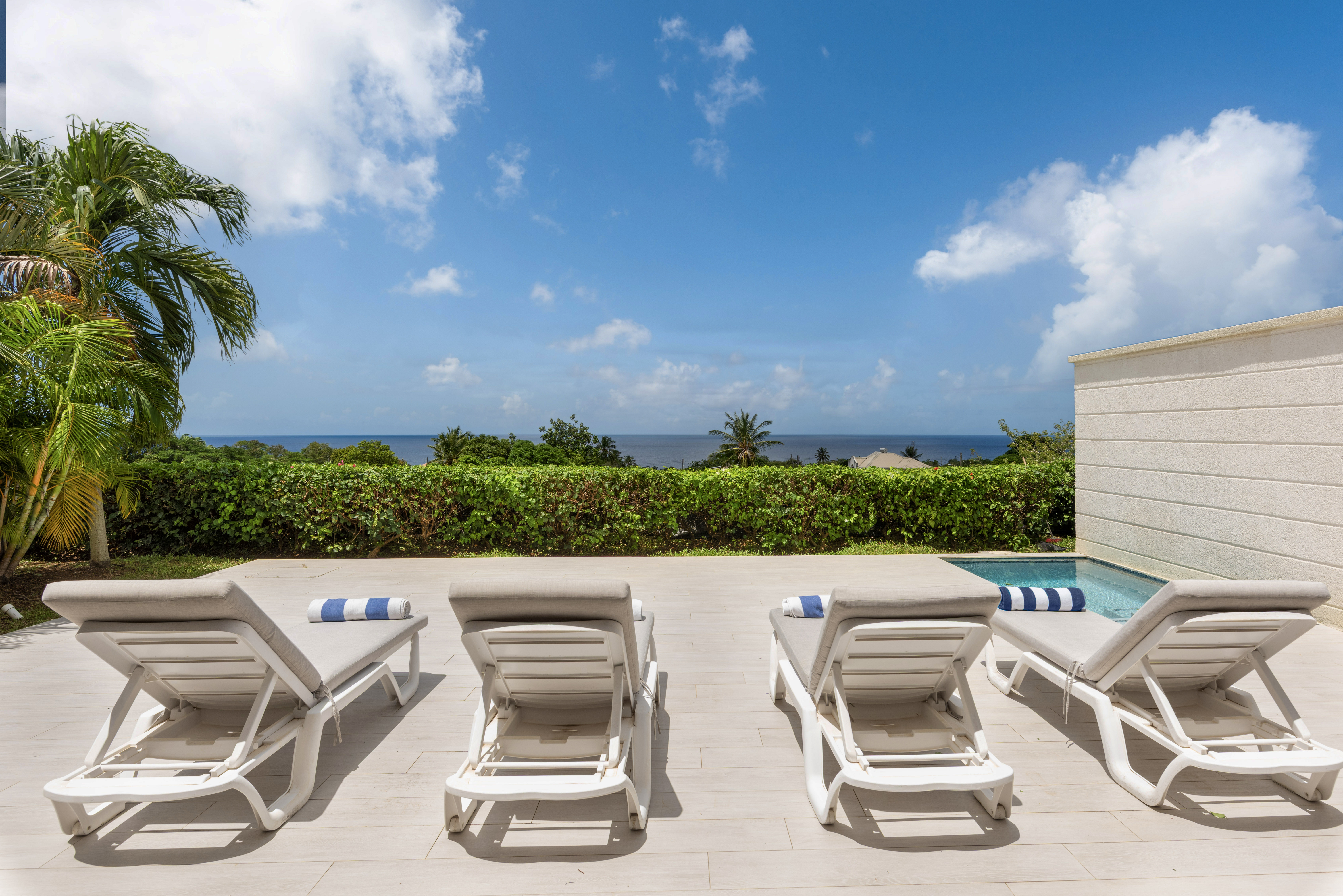Private ocean-view terrace with loungers and a refreshing plunge pool