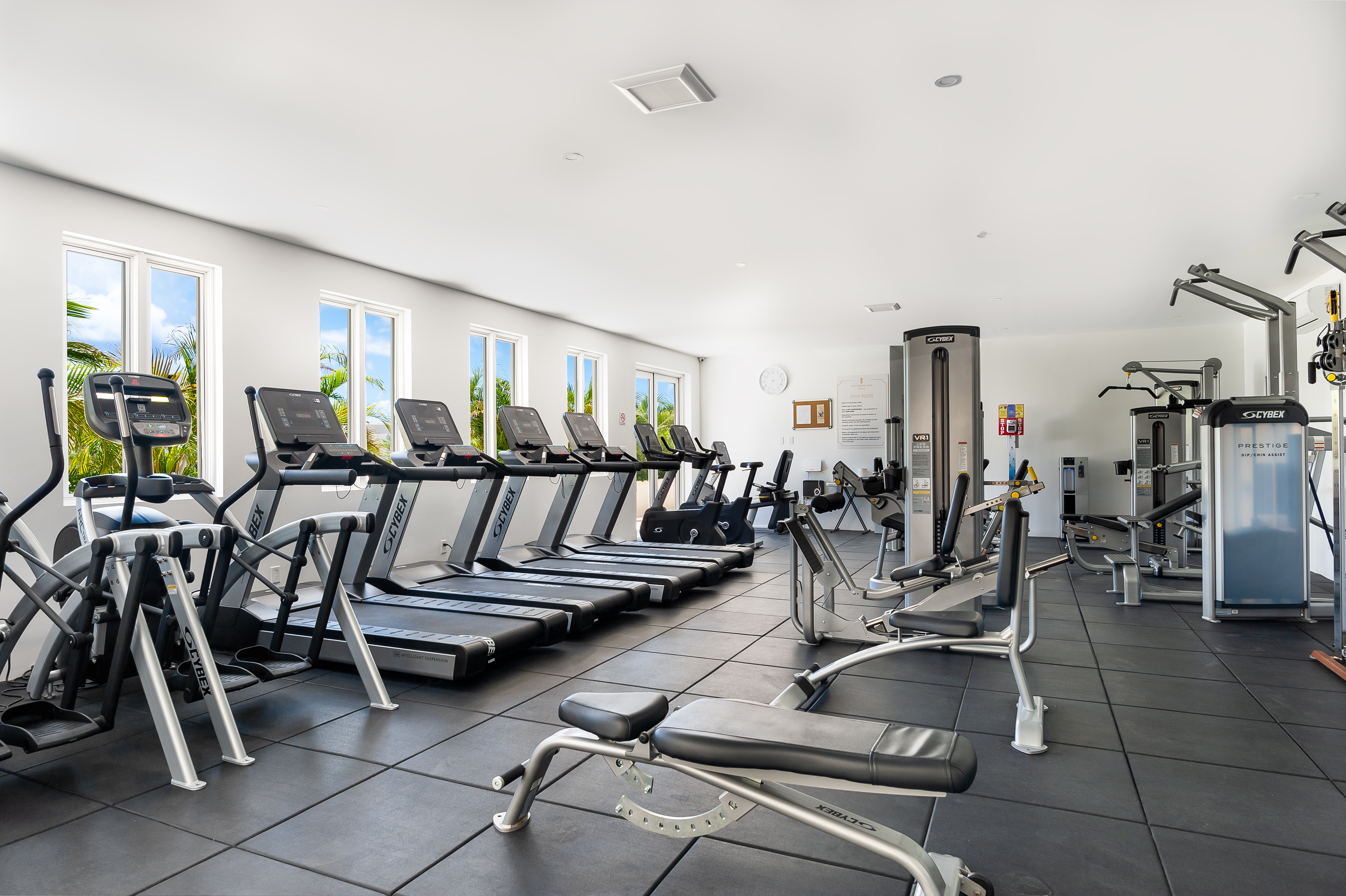 Bright, spacious fitness center with treadmills, weights, and natural light