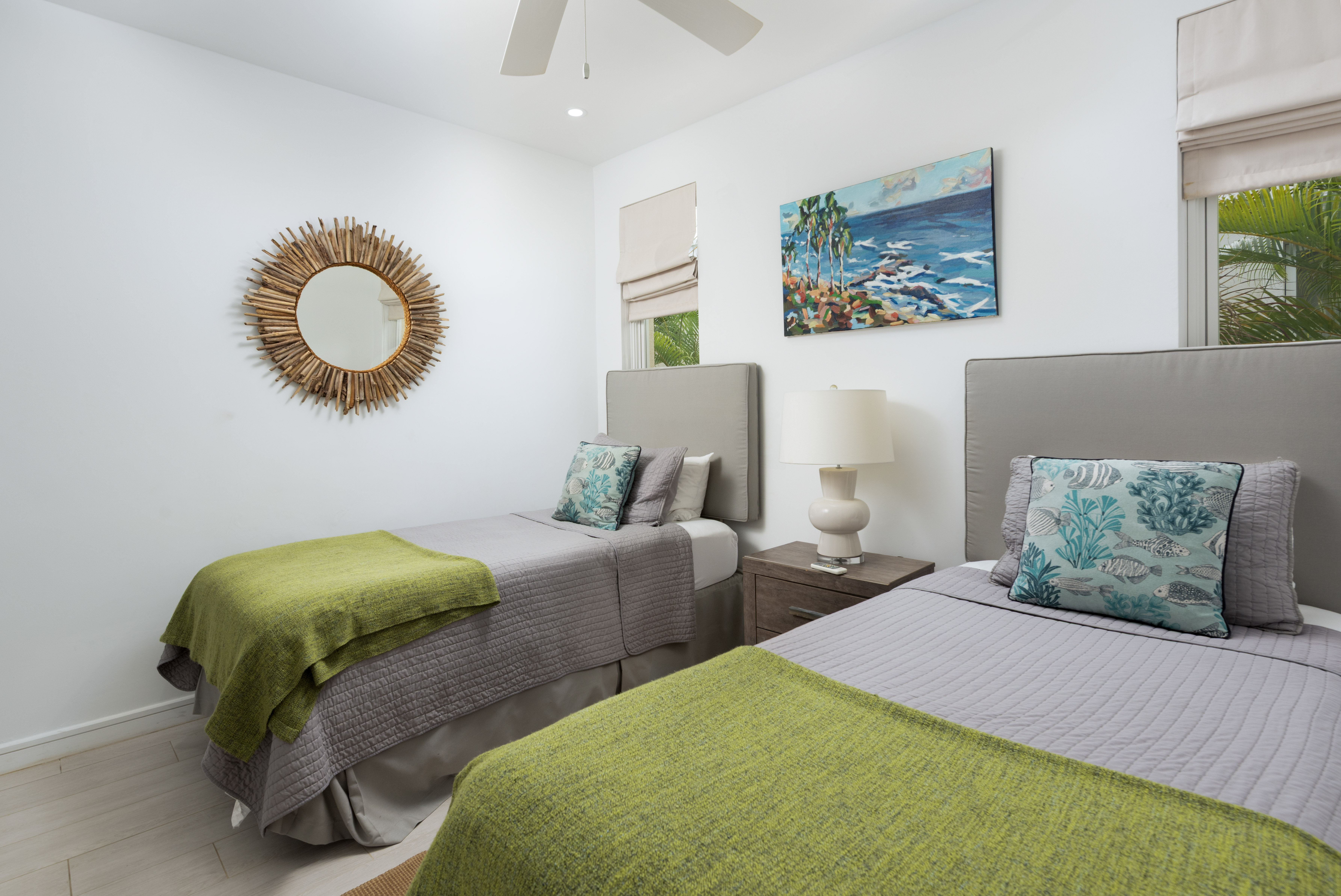 Bright coastal twin bedroom with tropical touches and natural light