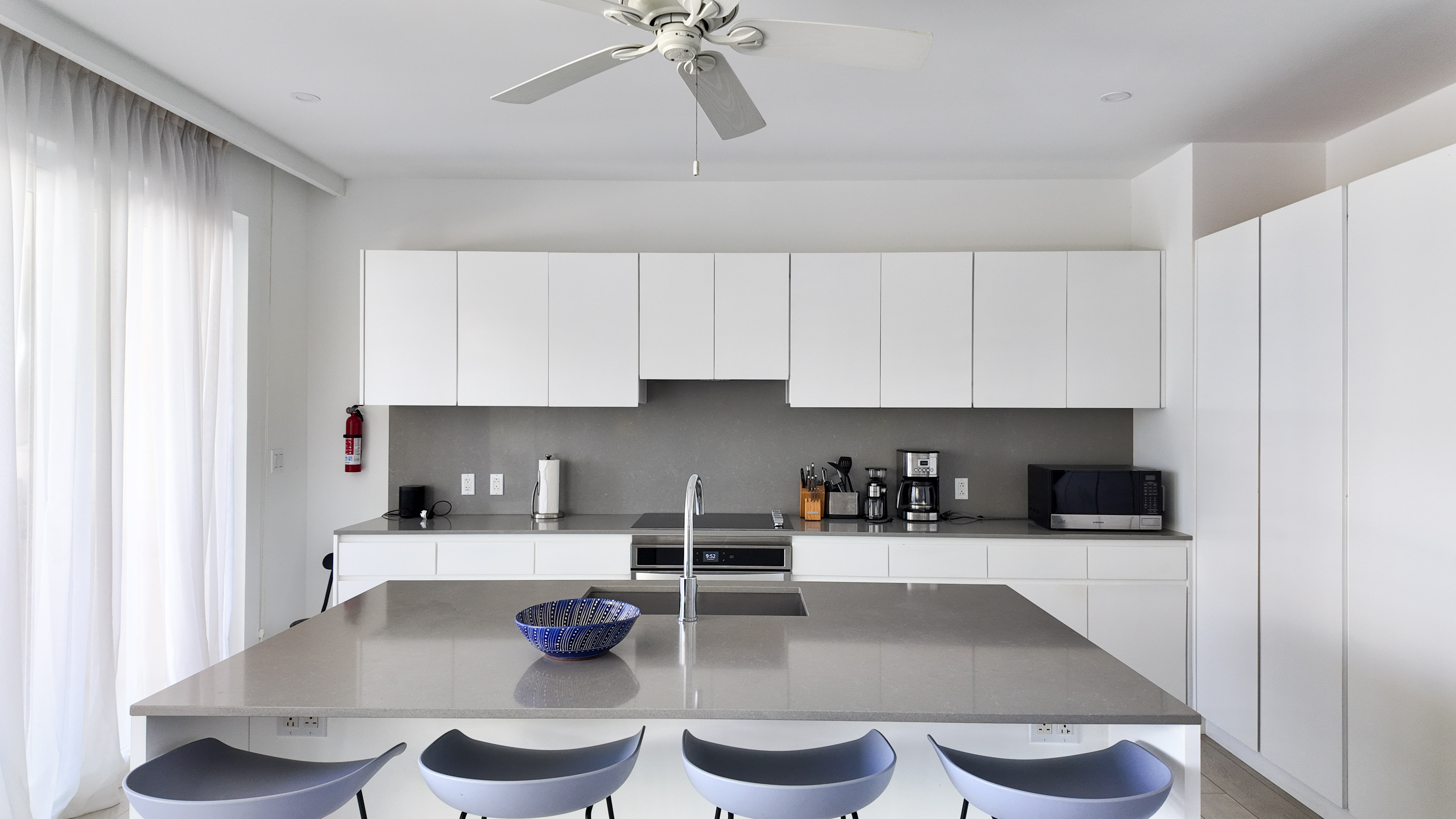 Bright modern kitchen with oversized island and seating for four