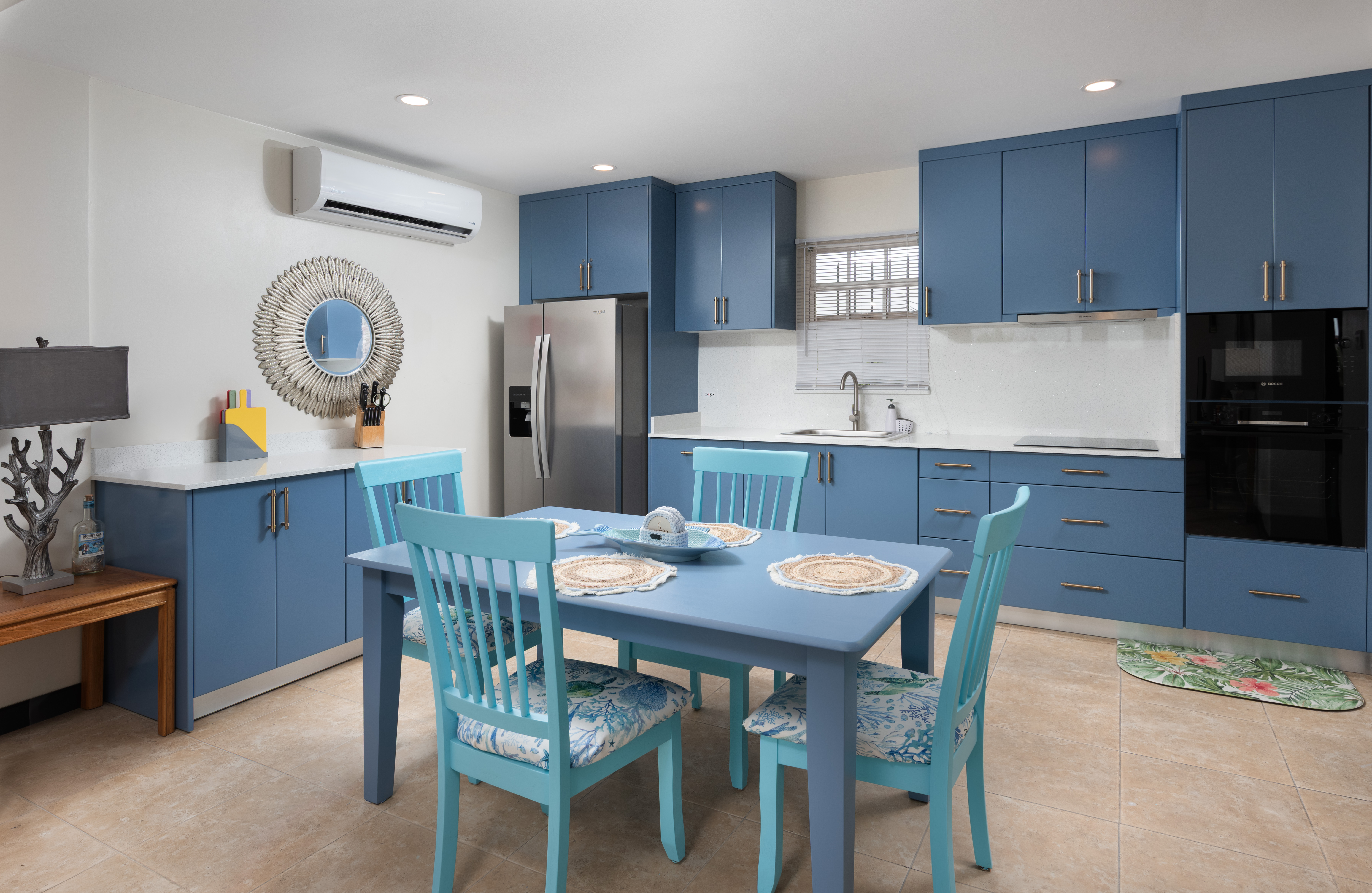 Bright blue kitchen with dining space and cheerful coastal style
