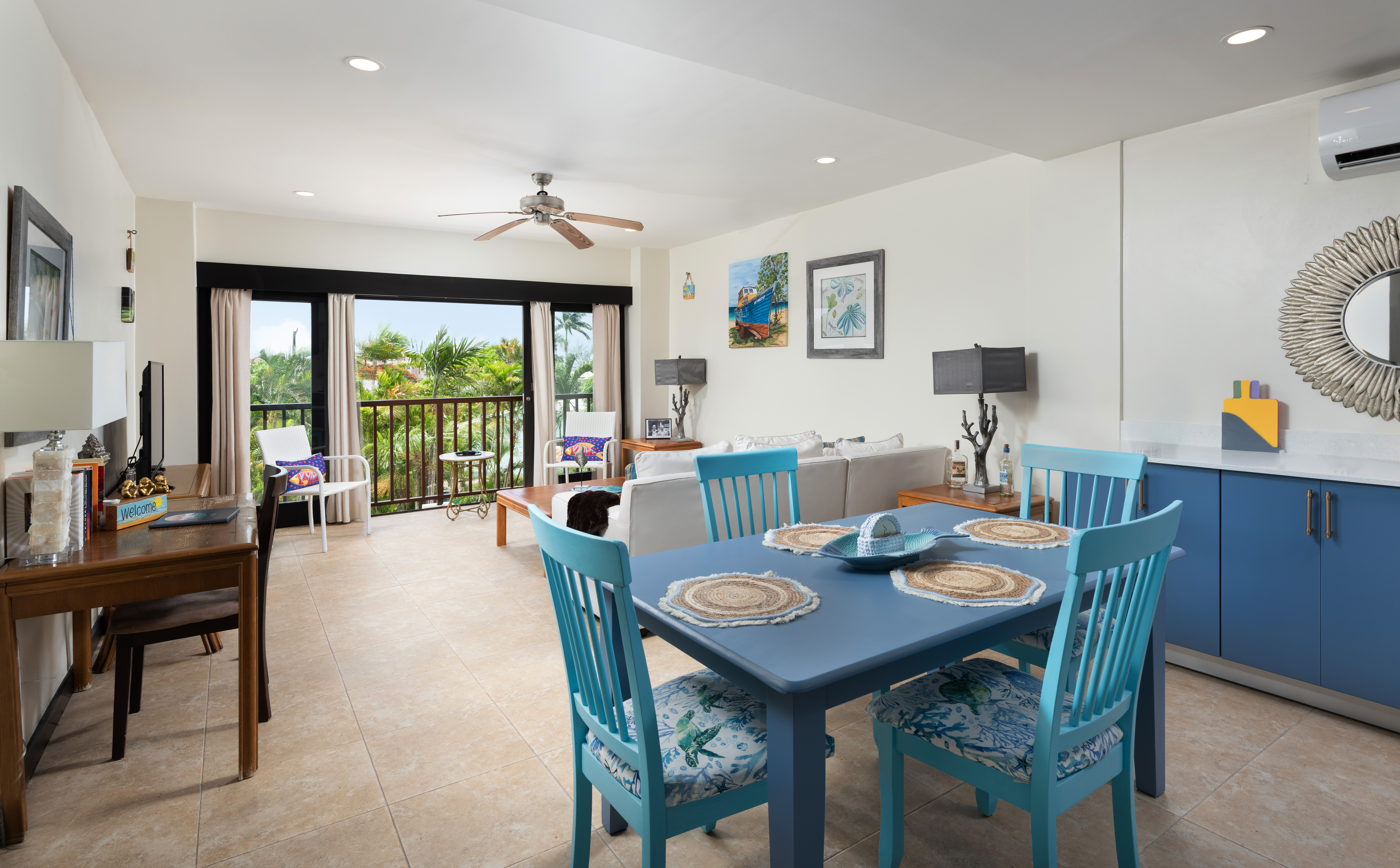 Bright tropical living space with balcony views and coastal charm