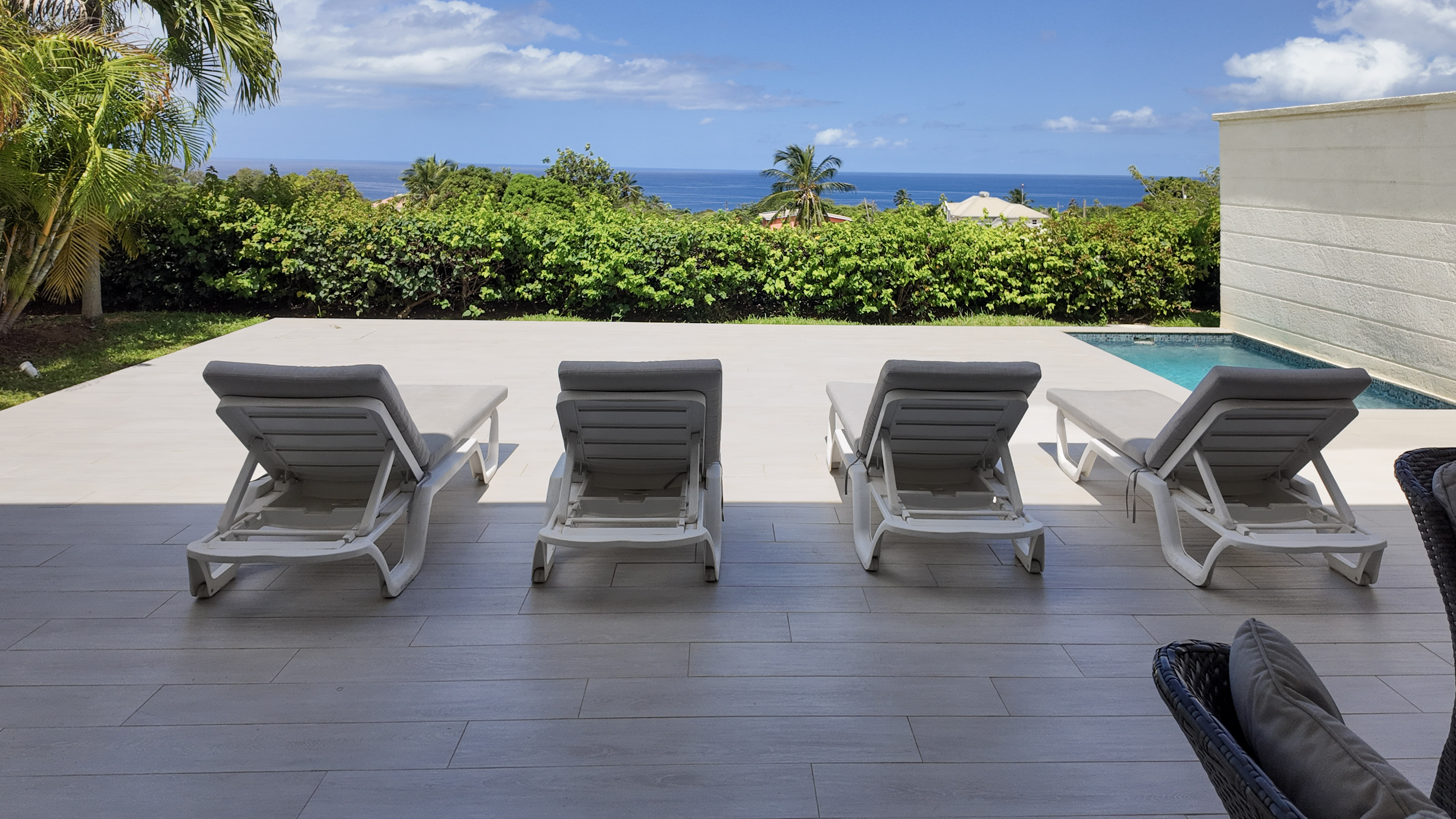 Private pool terrace with loungers and serene ocean views
