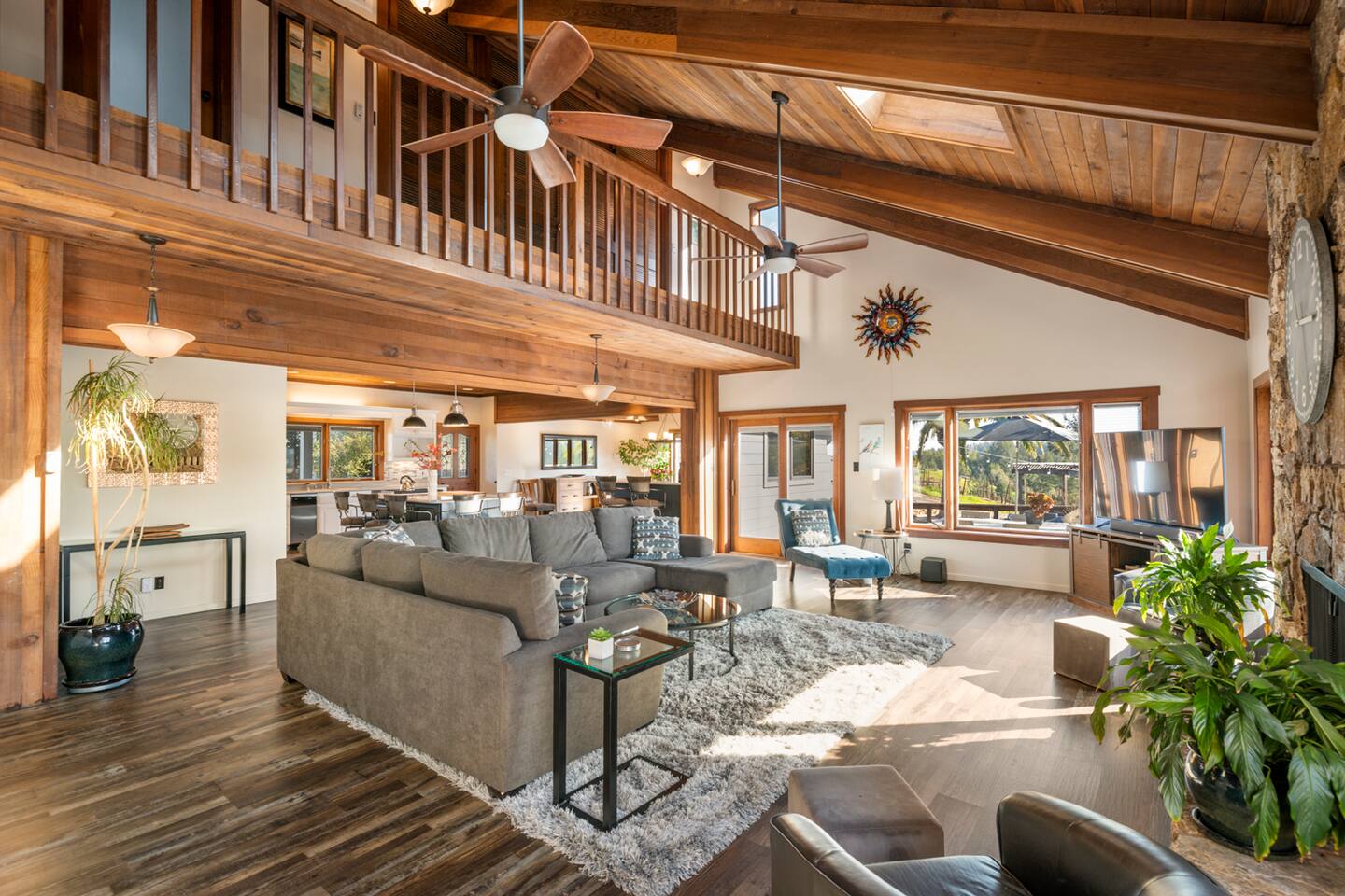 Experience the great room with its ceiling and elegant design. The seamless connection to the second floor, dining, and kitchen areas creates an open, airy feel, perfect for relaxed, expansive living and effortless entertaining.