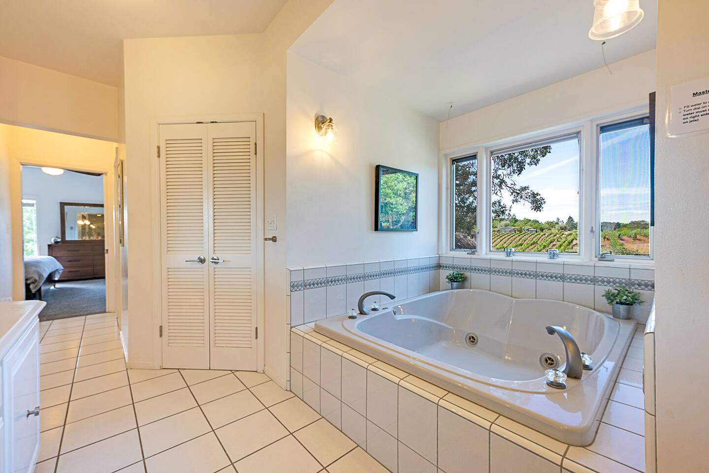 Indulge in a romantic retreat with the primary bathroom’s whirlpool tub, designed for two. Relax in soothing jets while taking in stunning views, transforming your bath into a private, luxurious escape for two.