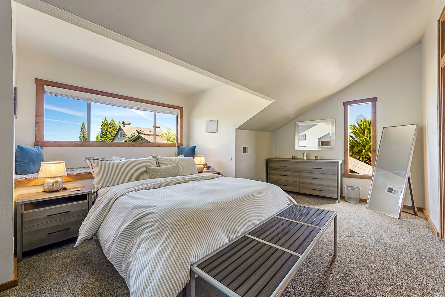 Relax in the charming upstairs queen bedroom with a cozy window seat. Bask in the natural light that floods the room, creating a bright and inviting space perfect for unwinding with a good book or simply enjoying the view.