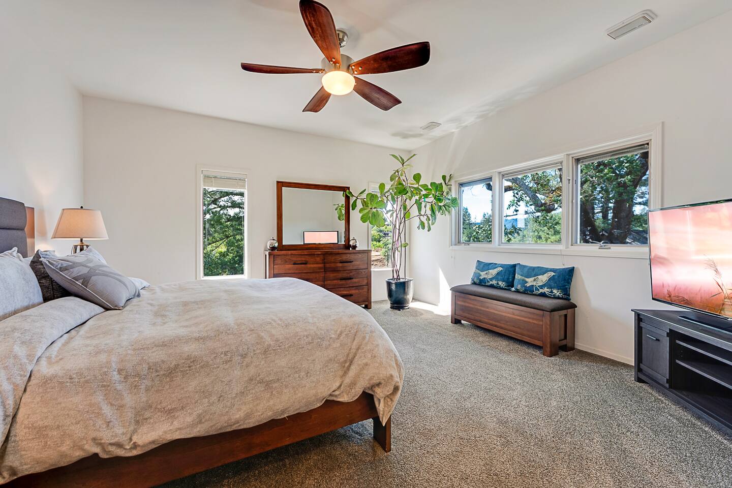 Retreat to the serene upstairs primary bedroom, bathed in natural light. Feel the ultimate comfort on a plush bed with hotel-quality linens, and unwind with your favorite shows on the smart TV. Enjoy a perfect blend of relaxation and luxury.