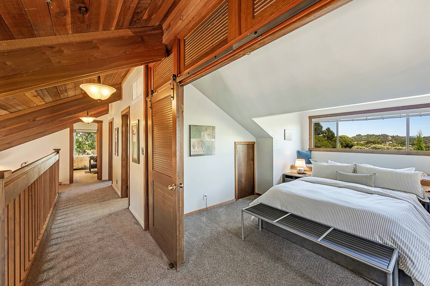 Relax in the charming upstairs queen bedroom with a cozy window seat. Bask in the natural light that floods the room, creating a bright and inviting space perfect for unwinding with a good book or simply enjoying the view.