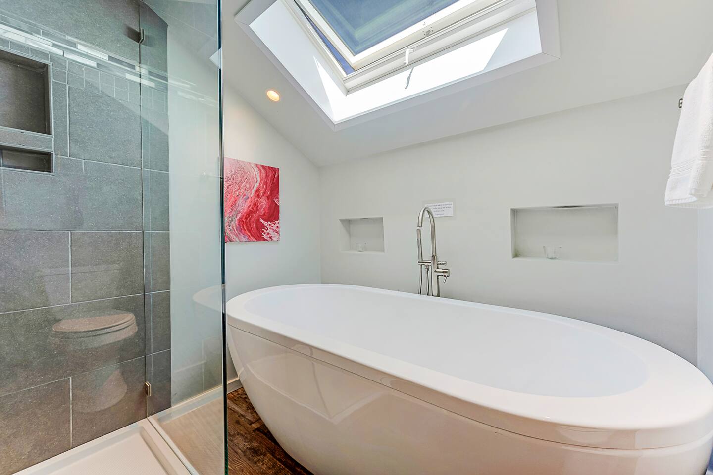 Refresh in the upstairs bathroom shower, featuring a sunroof with an operable skylight. Enjoy a revitalizing shower by day and unwind under the stars by night. 