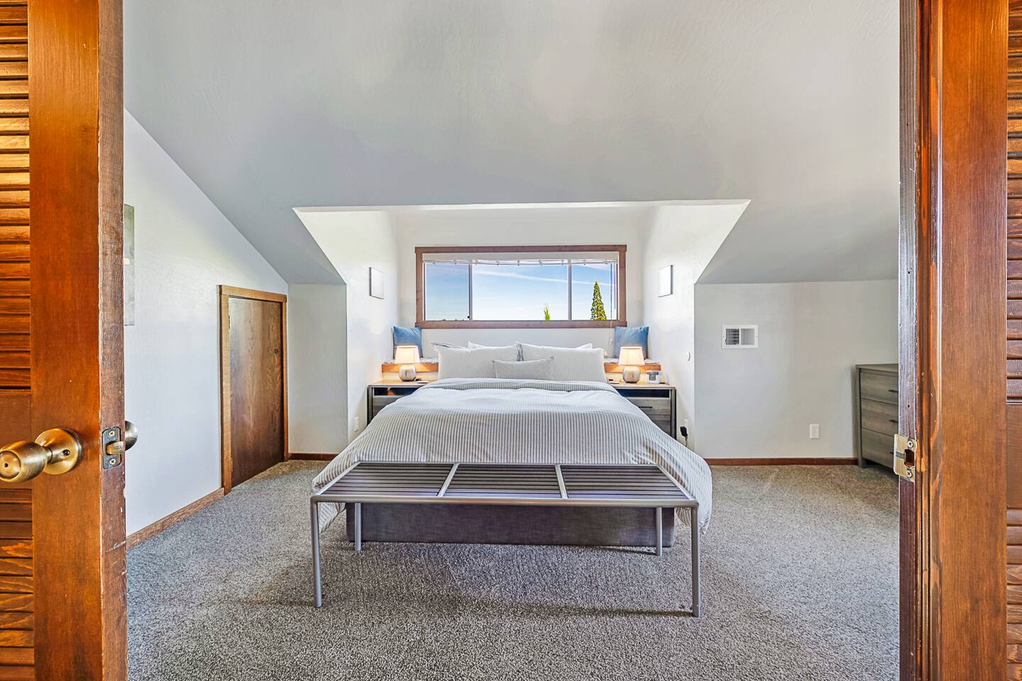 Relax in the charming upstairs queen bedroom with a cozy window seat. Bask in the natural light that floods the room, creating a bright and inviting space perfect for unwinding with a good book or simply enjoying the view.