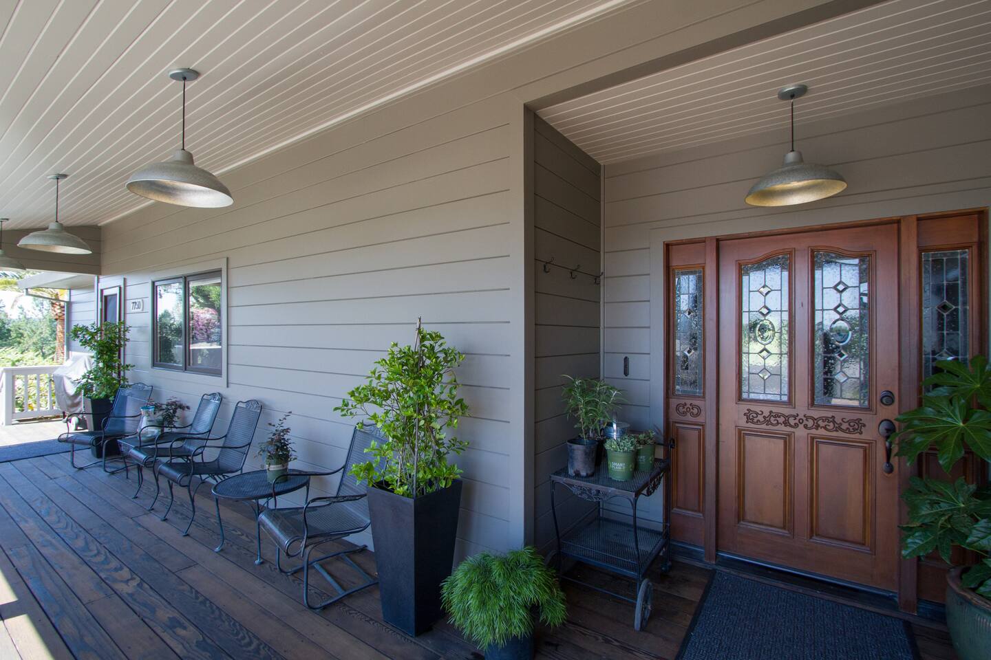 Welcome to our charming front porch and main entry, where cozy seating and inviting décor set the stage for relaxation. Perfect for enjoying morning coffee or greeting loved ones in a warm, welcoming atmosphere.