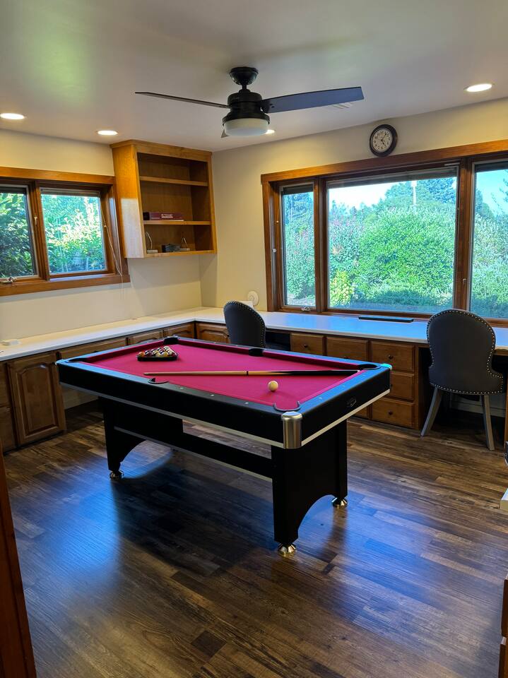 Our versatile game room, den, and office space offers stunning views and the perfect balance of fun and functionality. Enjoy a dedicated workspace, play pool or ping pong, or simply unwind—all in one comfortable and stylish setting.