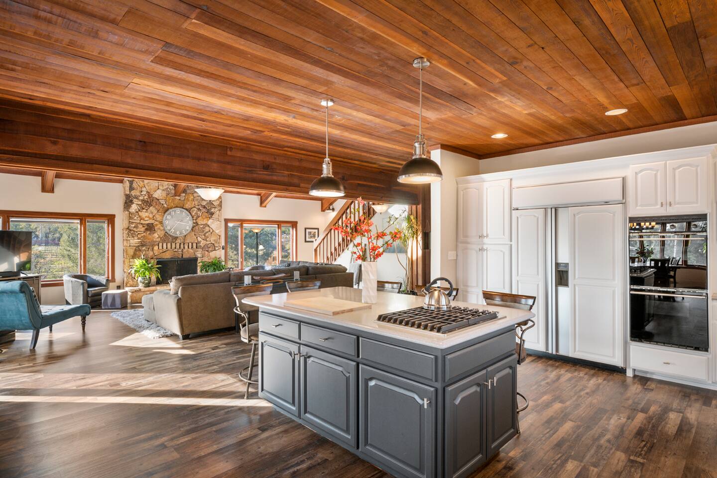 Our open-concept kitchen flows seamlessly into the dining and living areas, creating a cozy atmosphere perfect for sharing meals and stories. Enjoy the serenity of picturesque vineyard views that add a touch of magic to every moment.