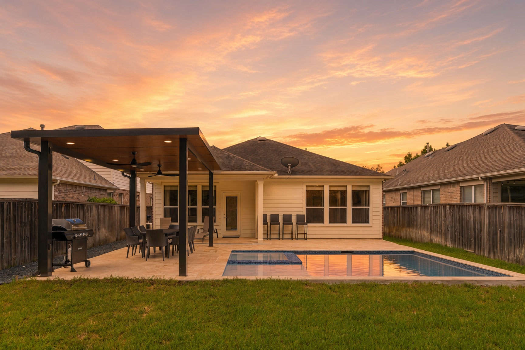 Private pool, spa, and covered patio glowing at sunset