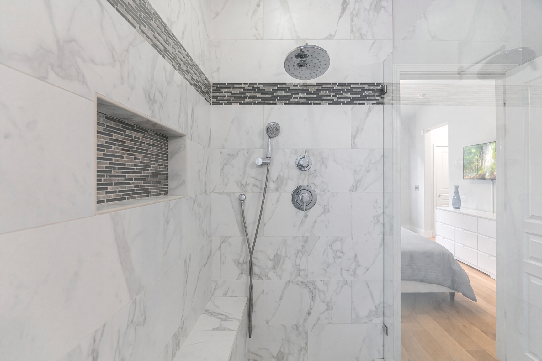 Spa-like marble walk-in shower with rainfall head and sleek glass enclosure