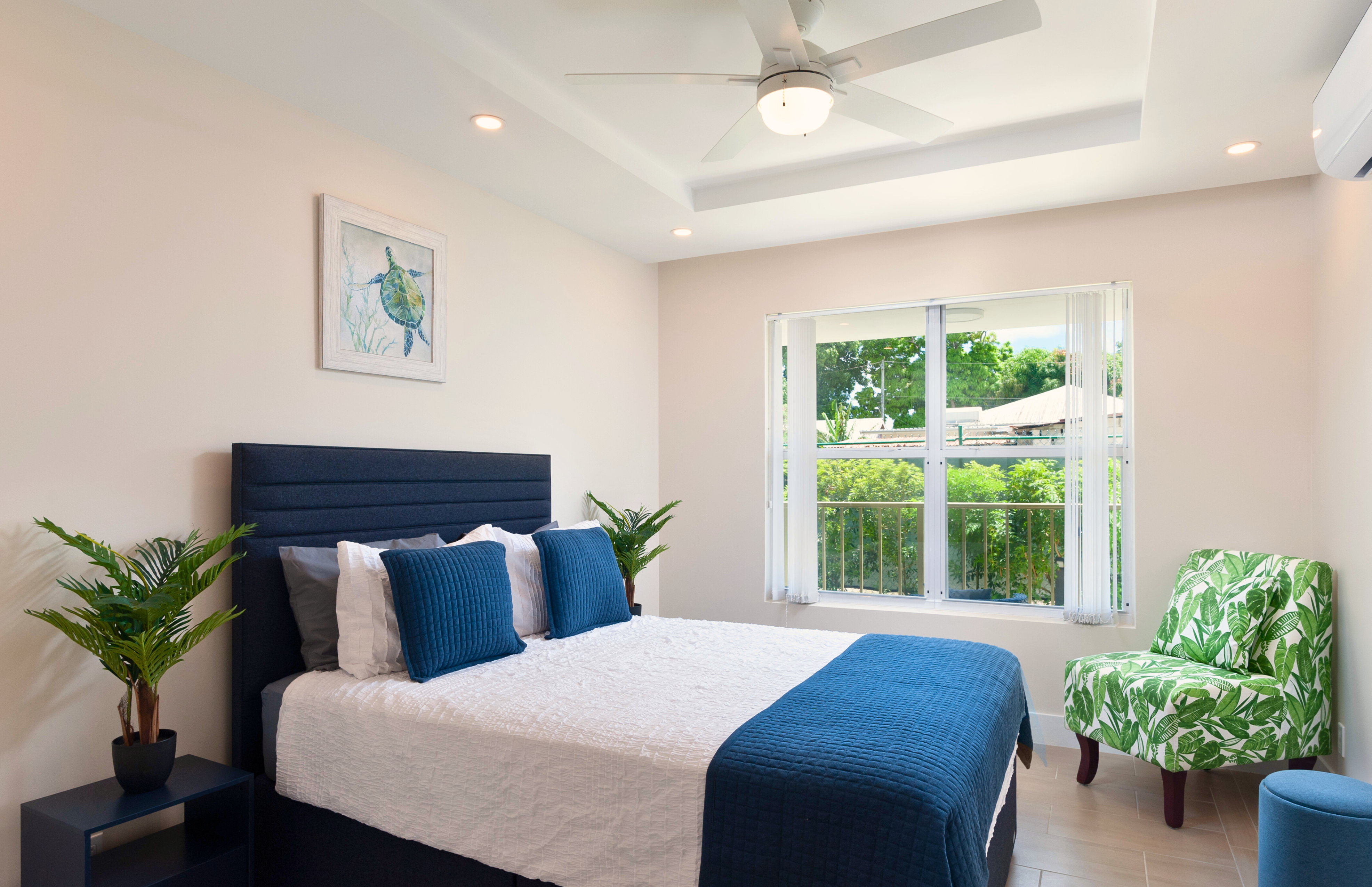 Bright, stylish bedroom with leafy views and tropical touches
