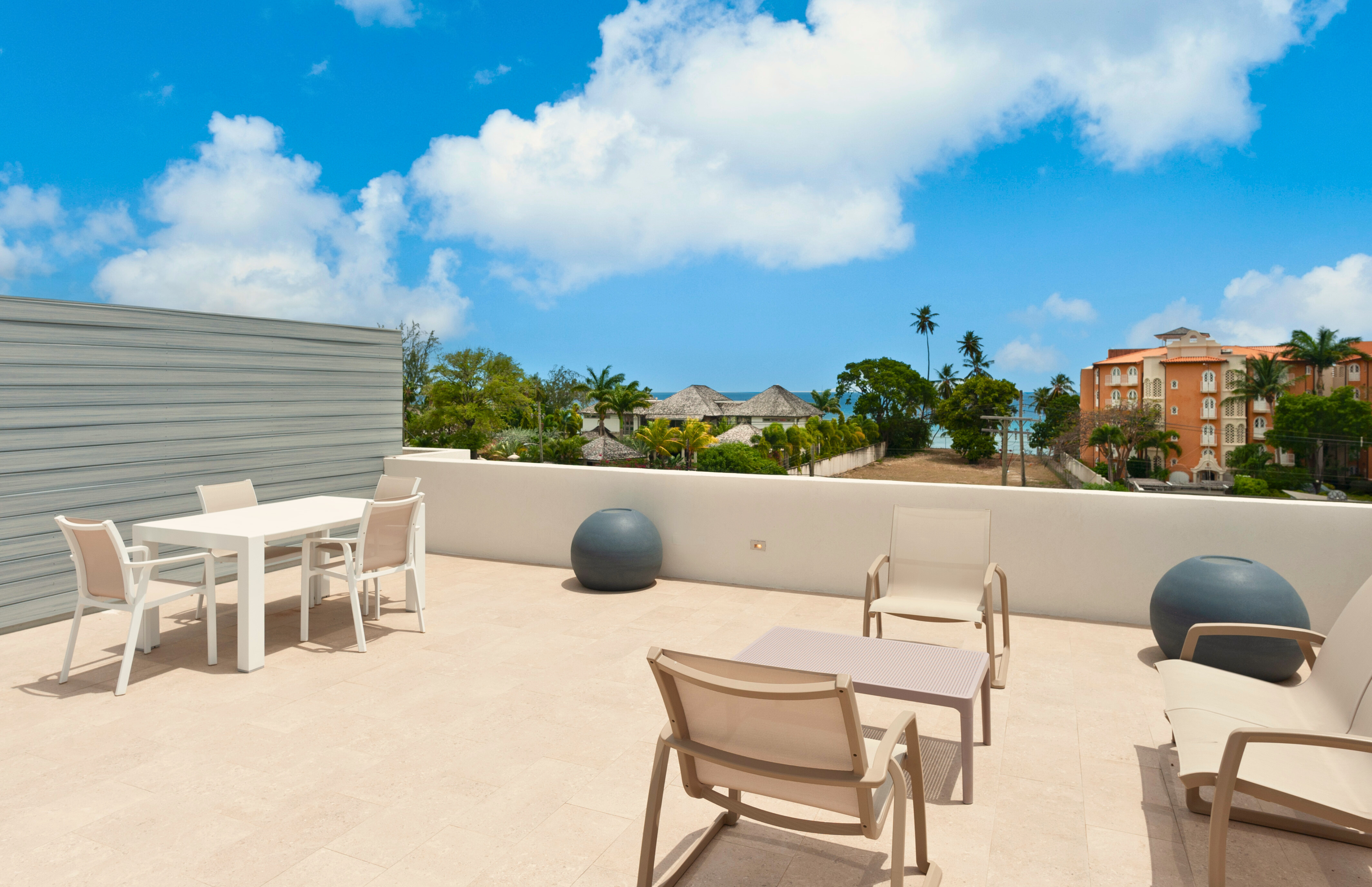 Spacious rooftop terrace with lounge seating and partial ocean views