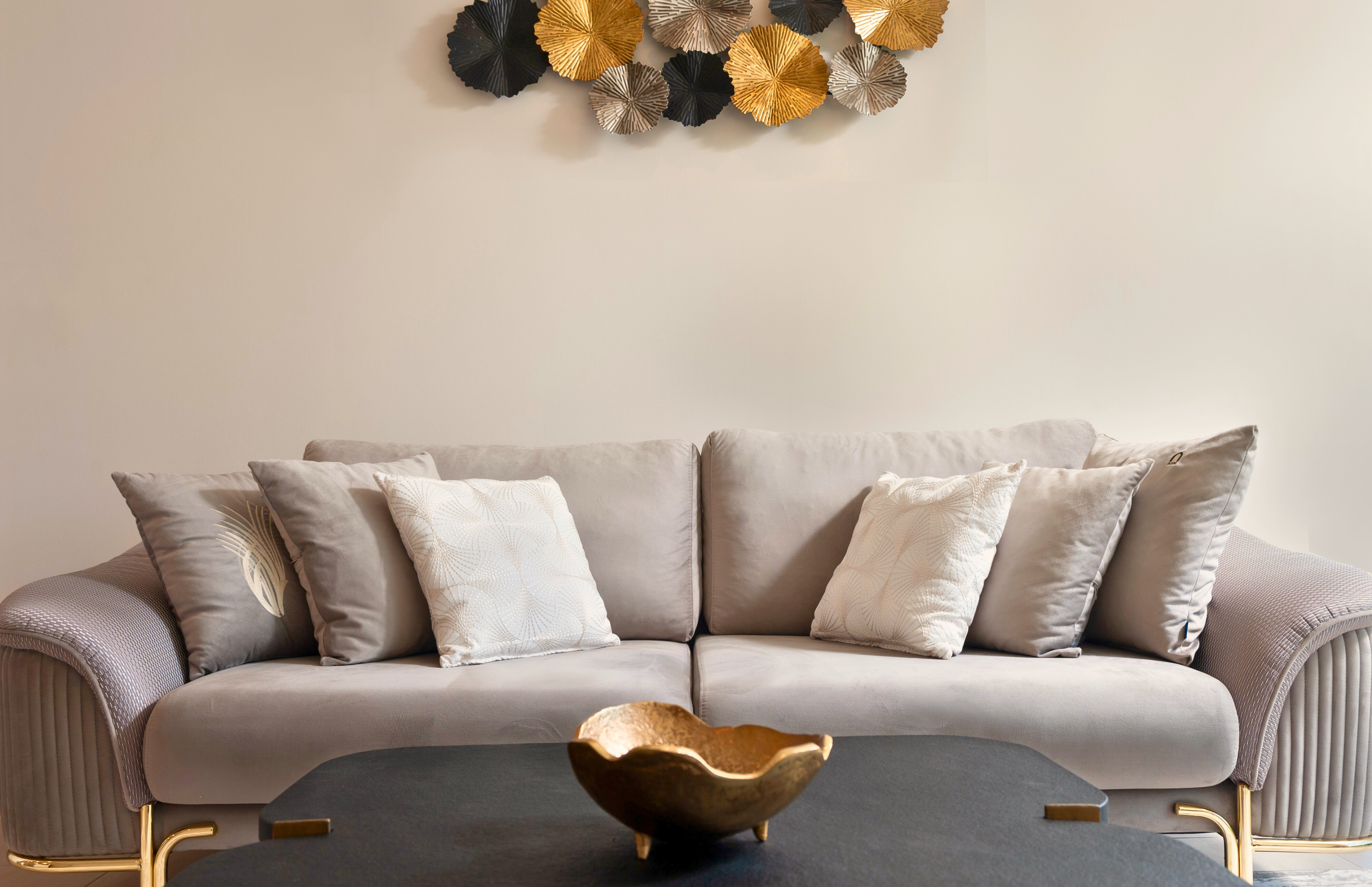 Elegant modern lounge with plush sofa and chic metallic wall art