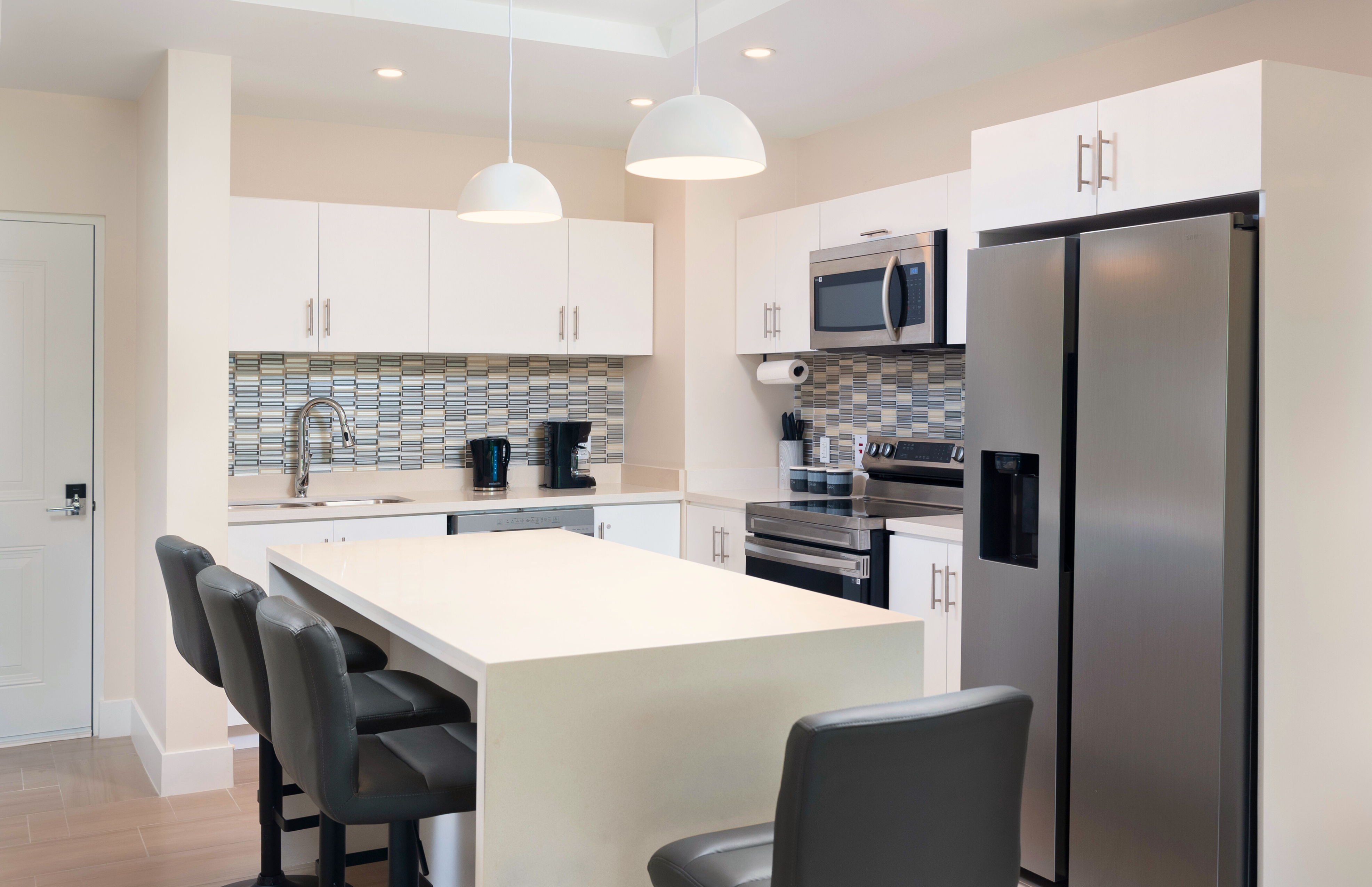 Bright modern kitchen with stainless appliances and spacious island seating