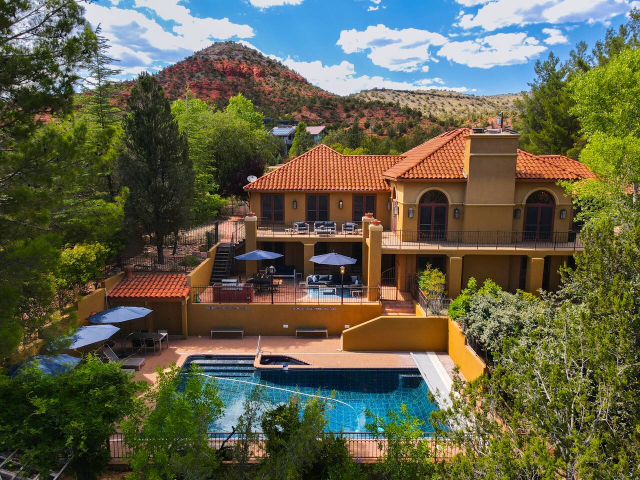 Luxury Retreat with Terraced Patios, Pool, and Red Rock backdrop 