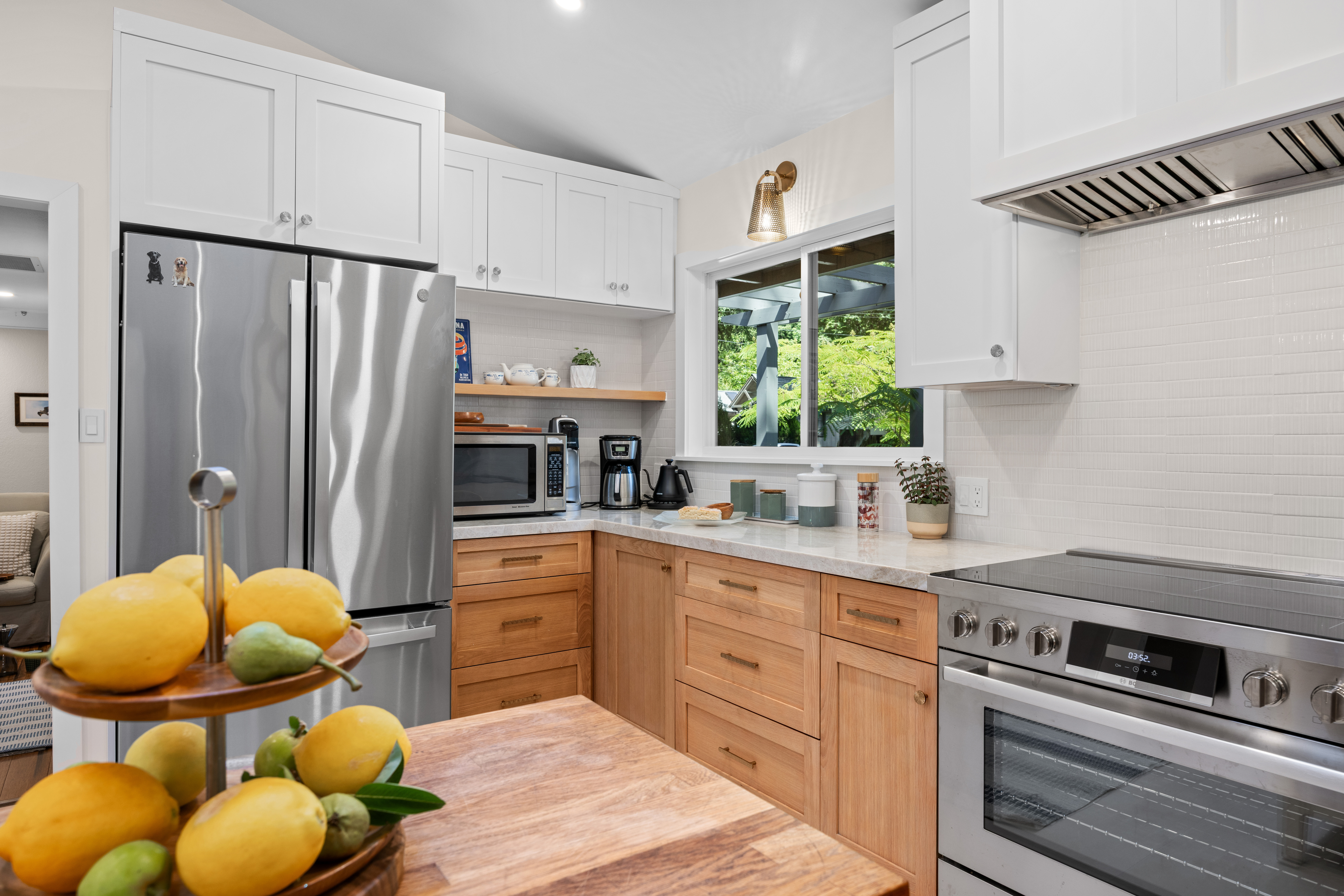 Bright modern kitchen with stainless appliances and serene garden views