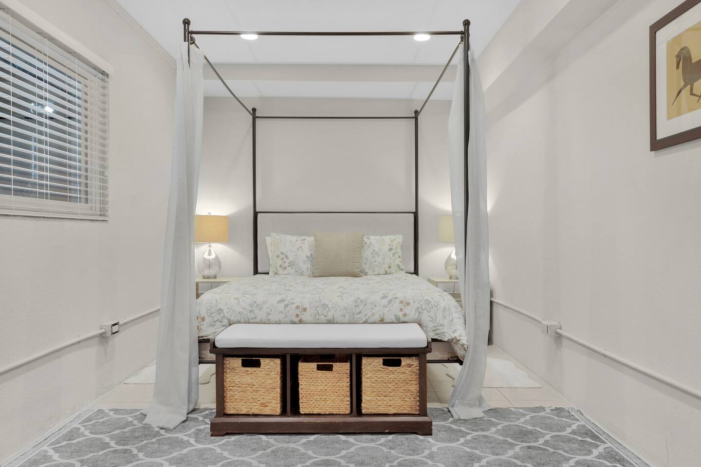 This cozy downstairs bedroom offers a serene escape for couples, featuring a comfortable queen bed and intimate decor. Perfect for a romantic getaway, it provides a peaceful retreat to relax and reconnect away from the hustle and bustle.