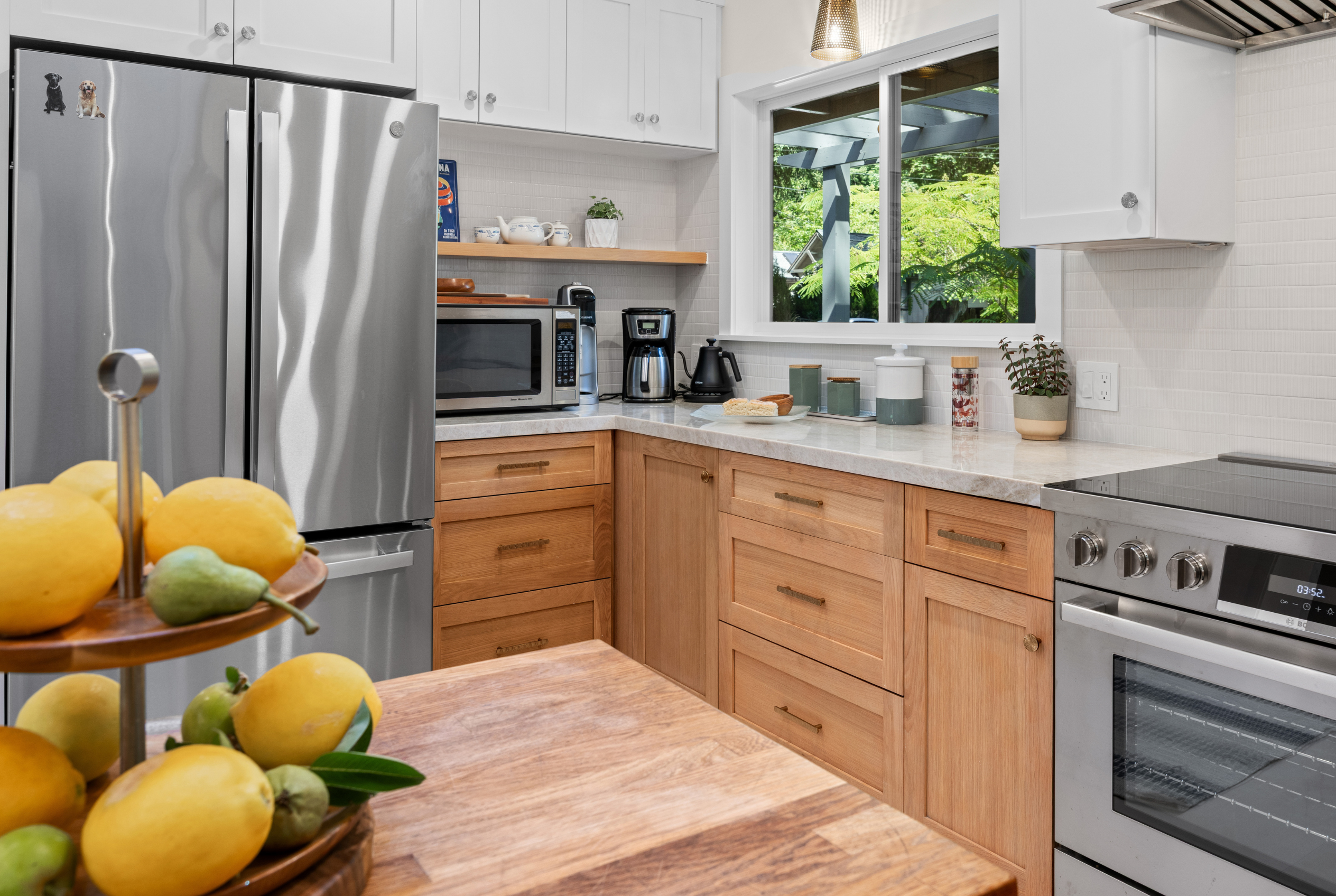 Bright modern kitchen with stainless appliances and garden-view window