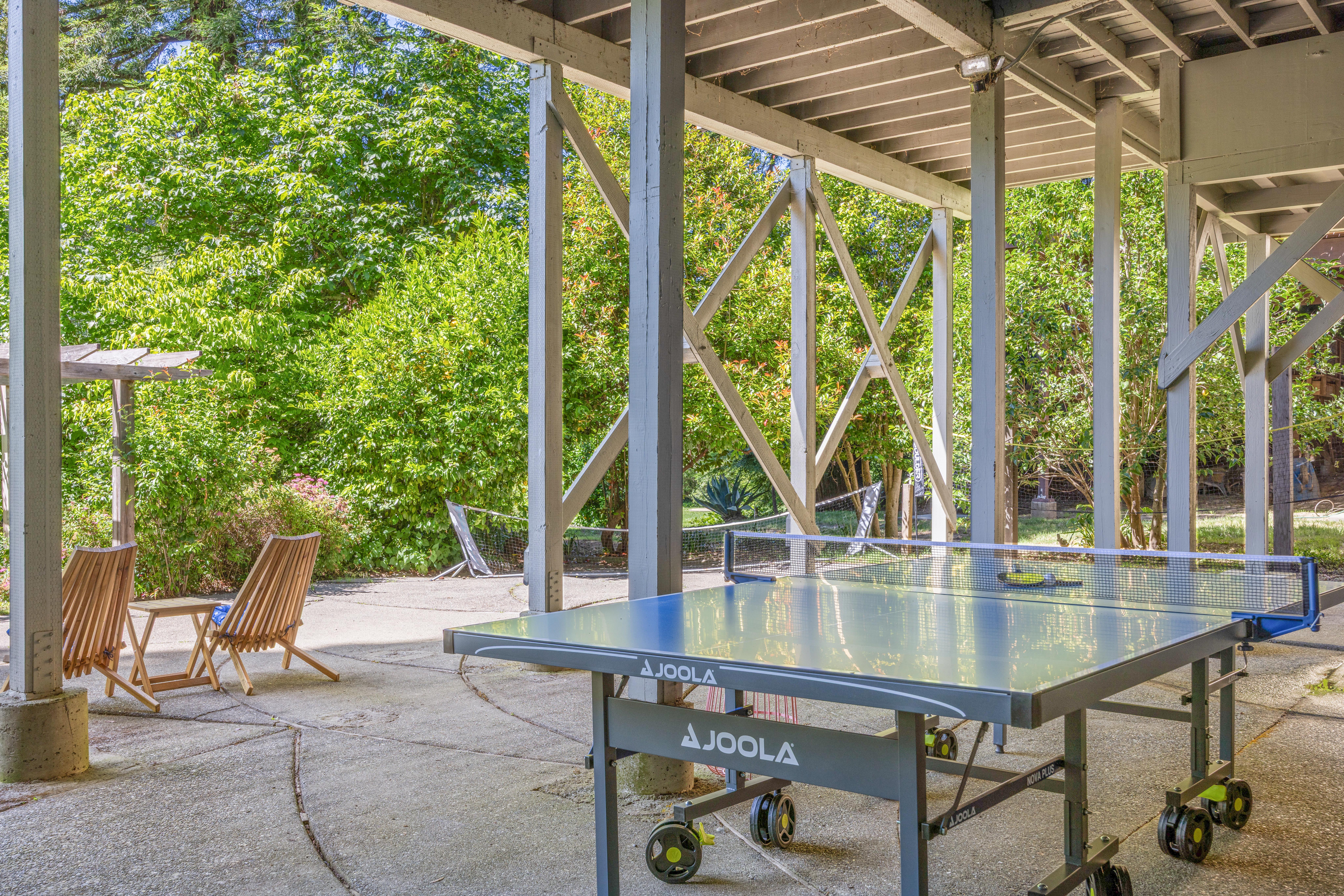 Covered patio with ping pong table and peaceful garden seating