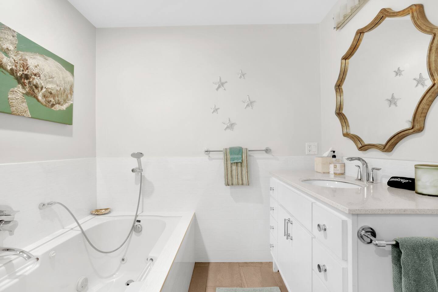 Clean and spacious shared bathroom featuring a relaxing tub, a sleek vanity sink, and a well-lit mirror to get ready for the day