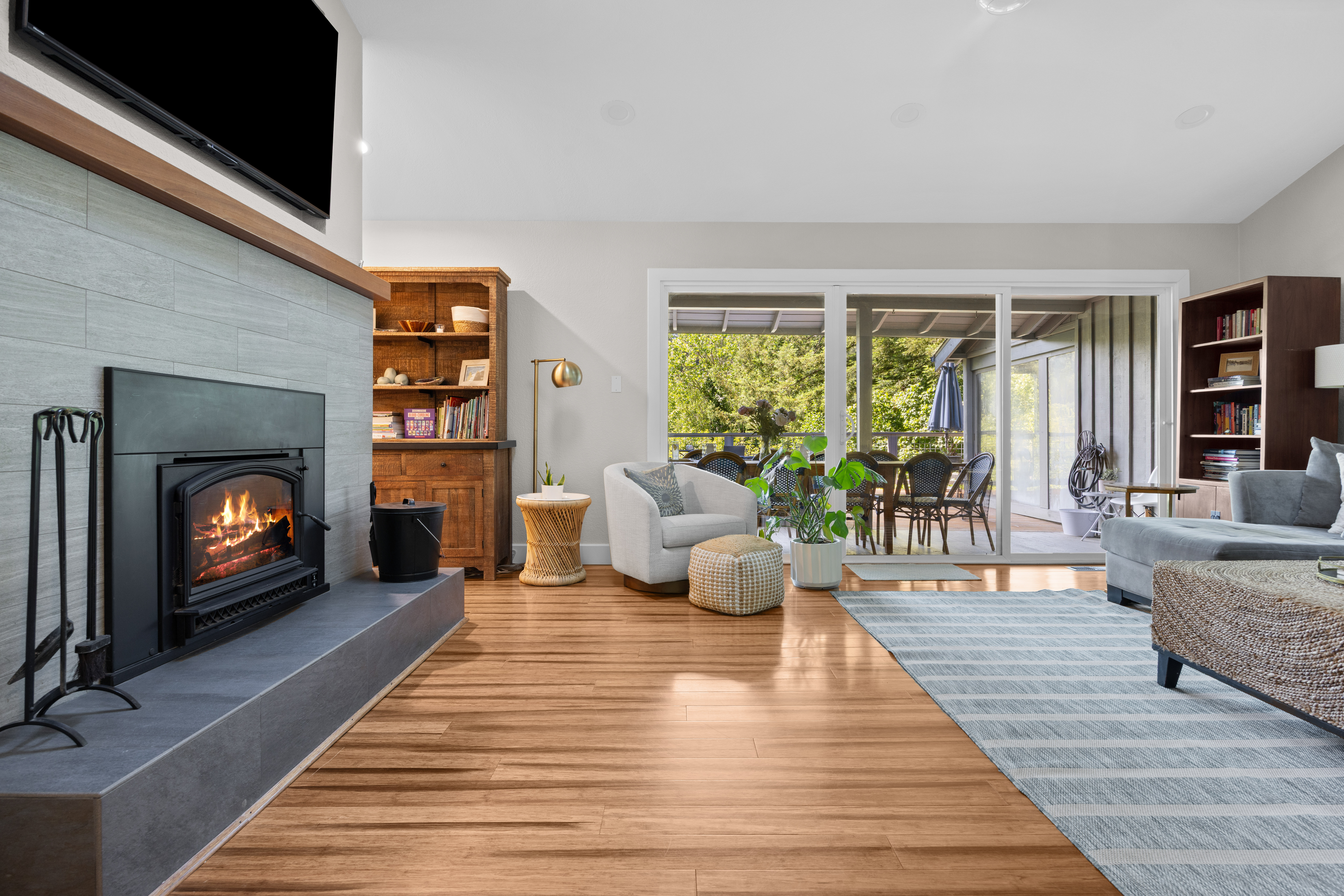 Bright living room with fireplace, TV, and seamless patio access