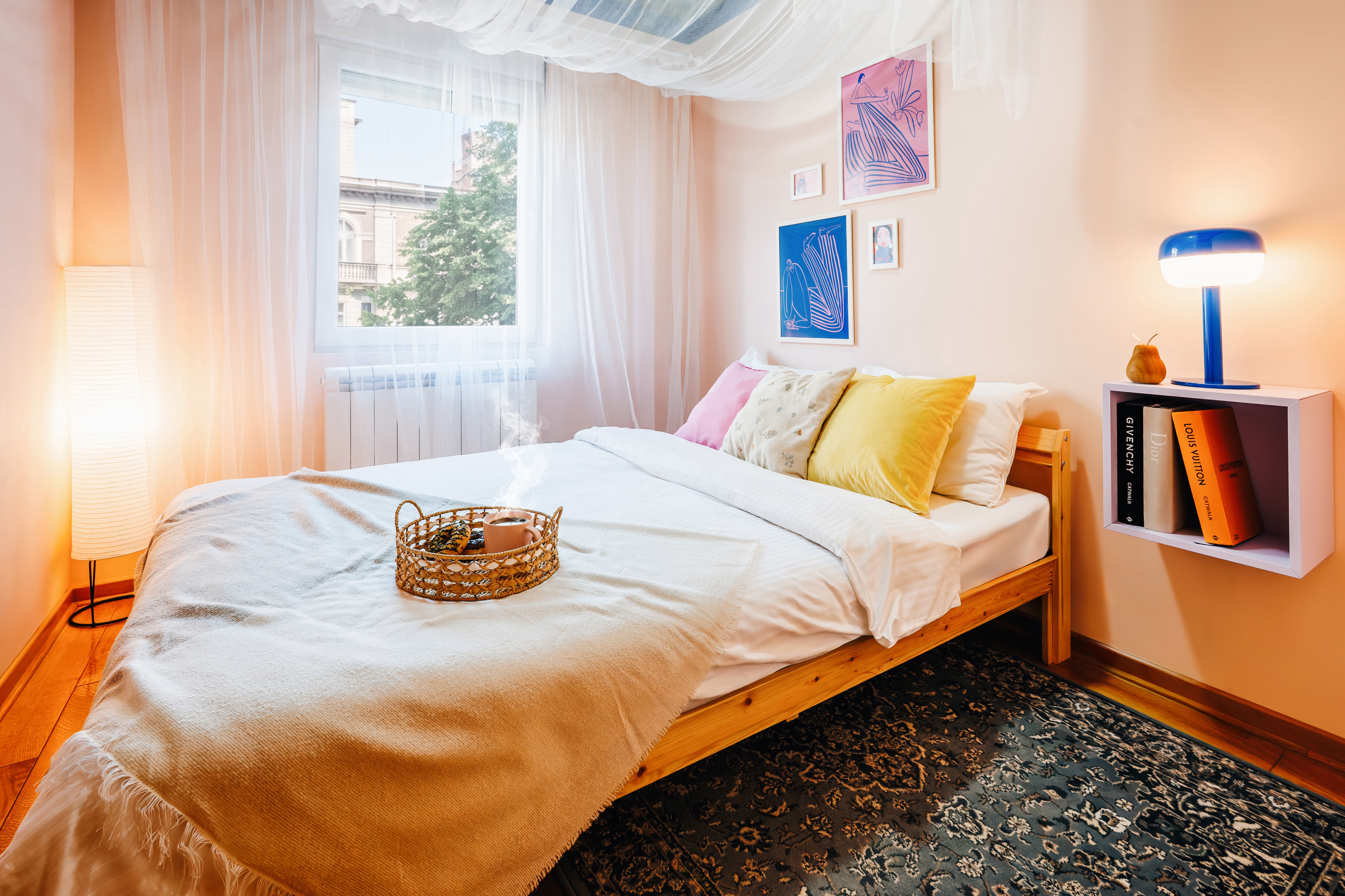 Bright, cozy bedroom with soft linens, warm lighting, and stylish decor