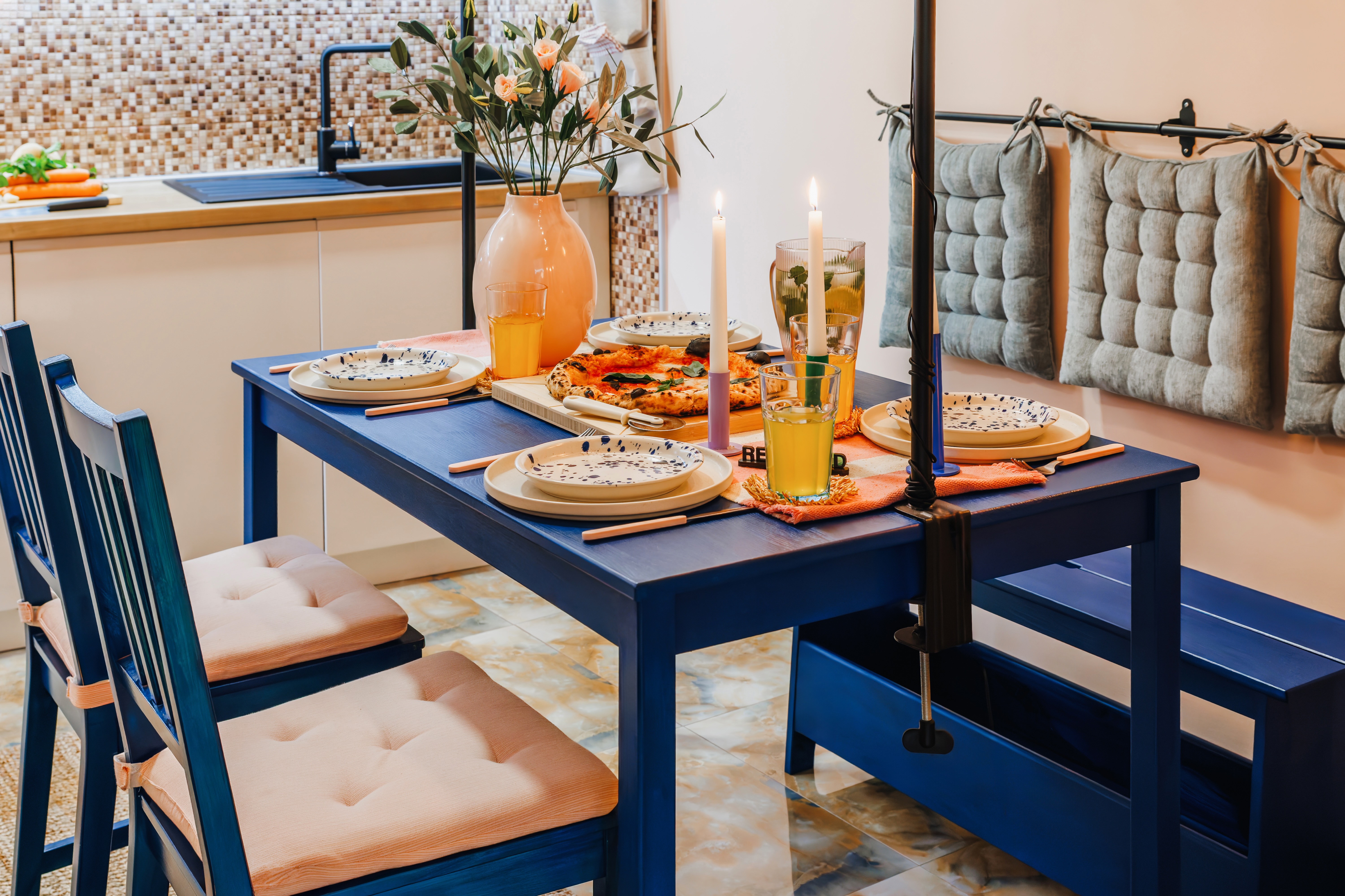 Chic dining nook with modern kitchen touches and cozy candlelit ambiance