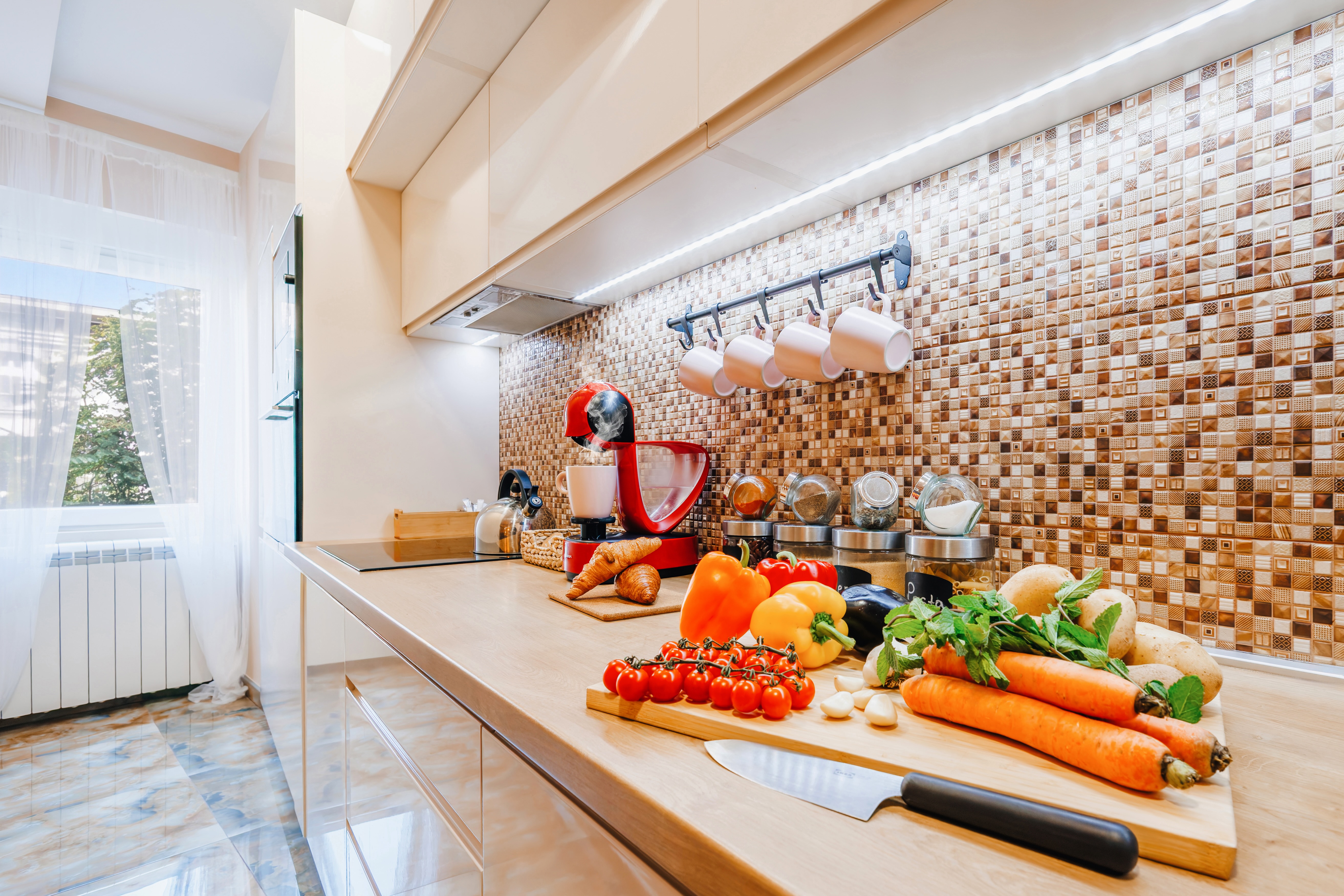 Bright modern kitchen with stylish backsplash and generous prep space