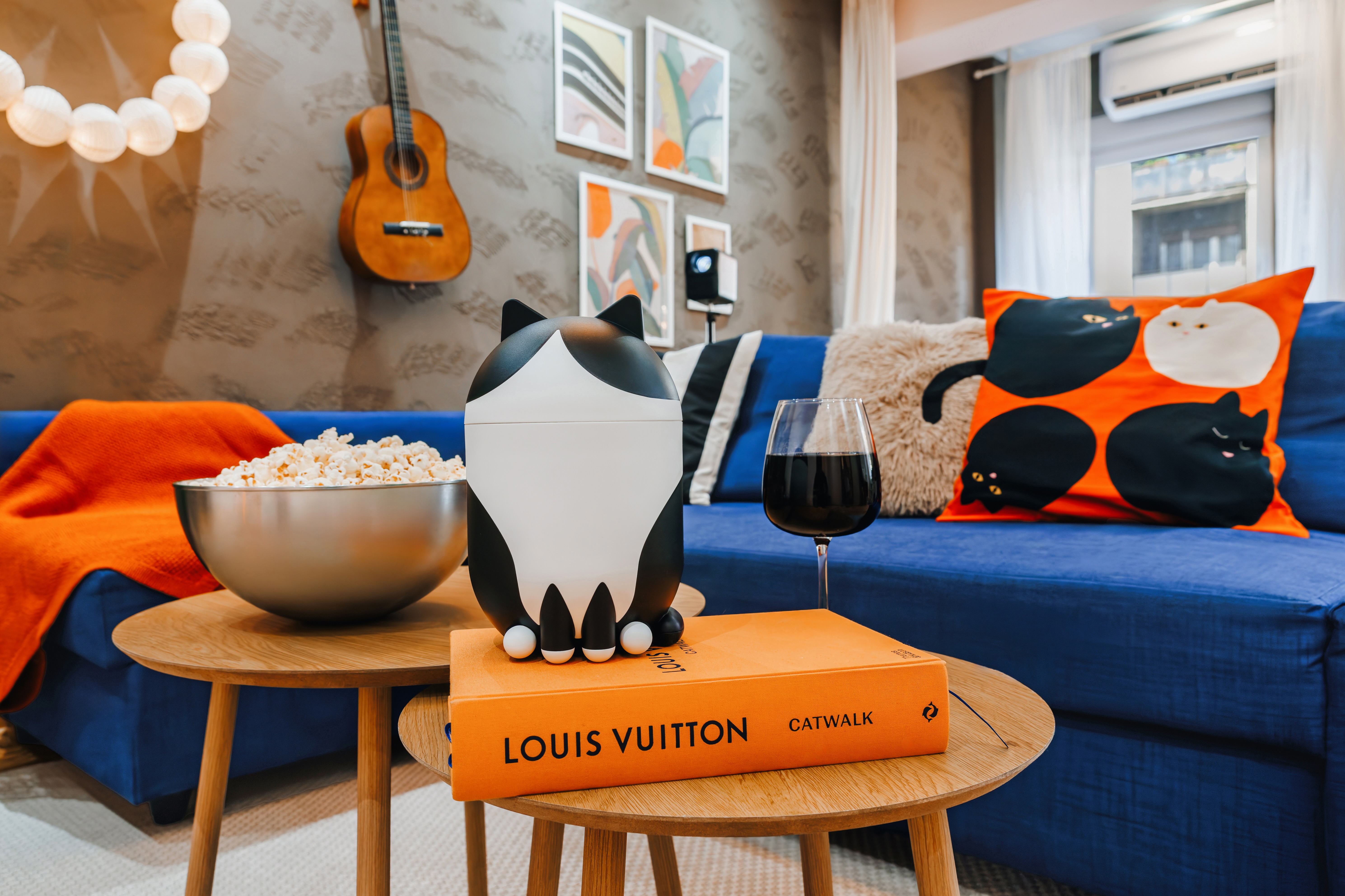 Stylish lounge with bold decor, comfy seating, and a cozy movie-night vibe