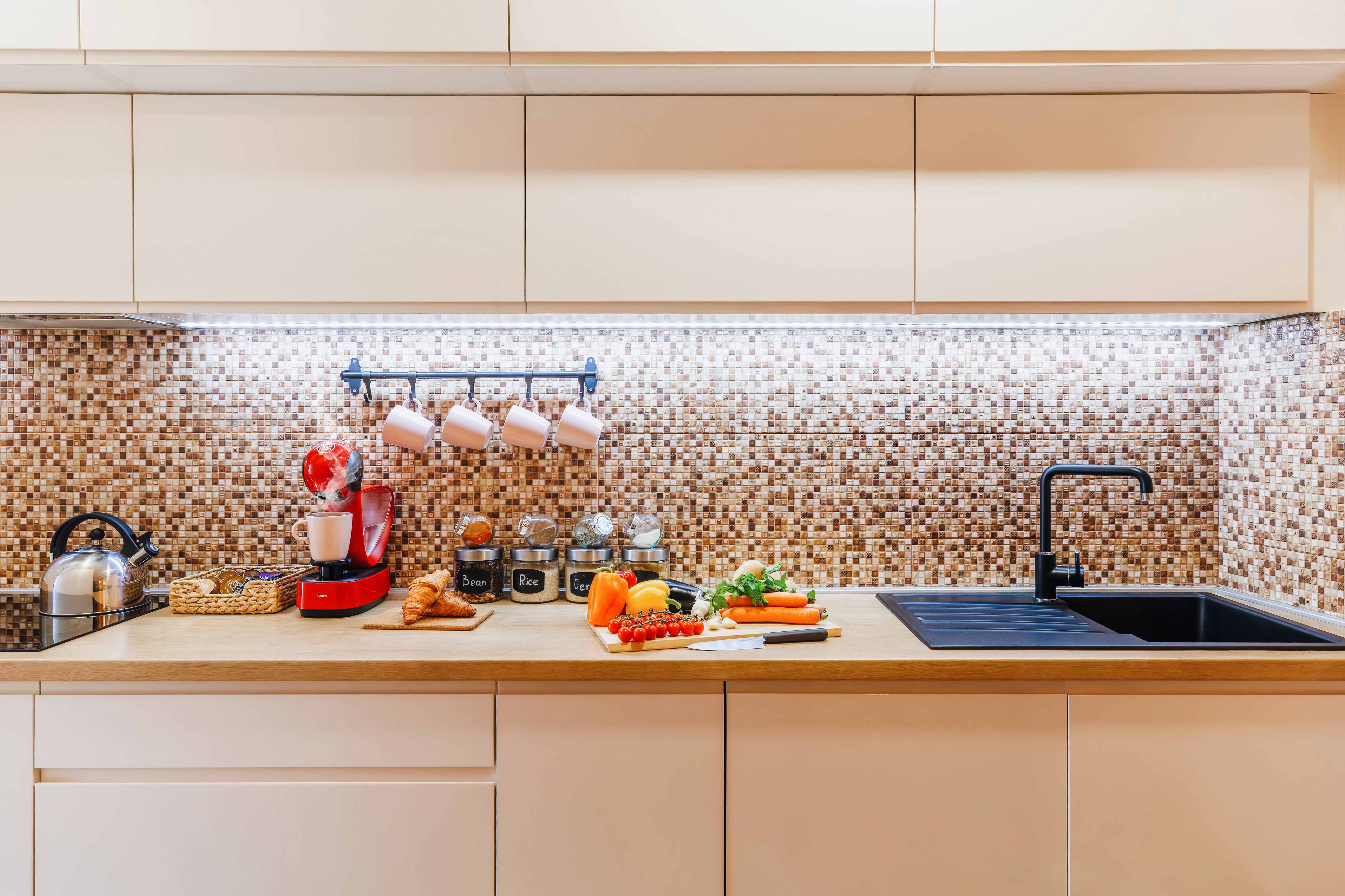 Bright modern kitchen with sleek finishes, coffee station, and roomy workspace
