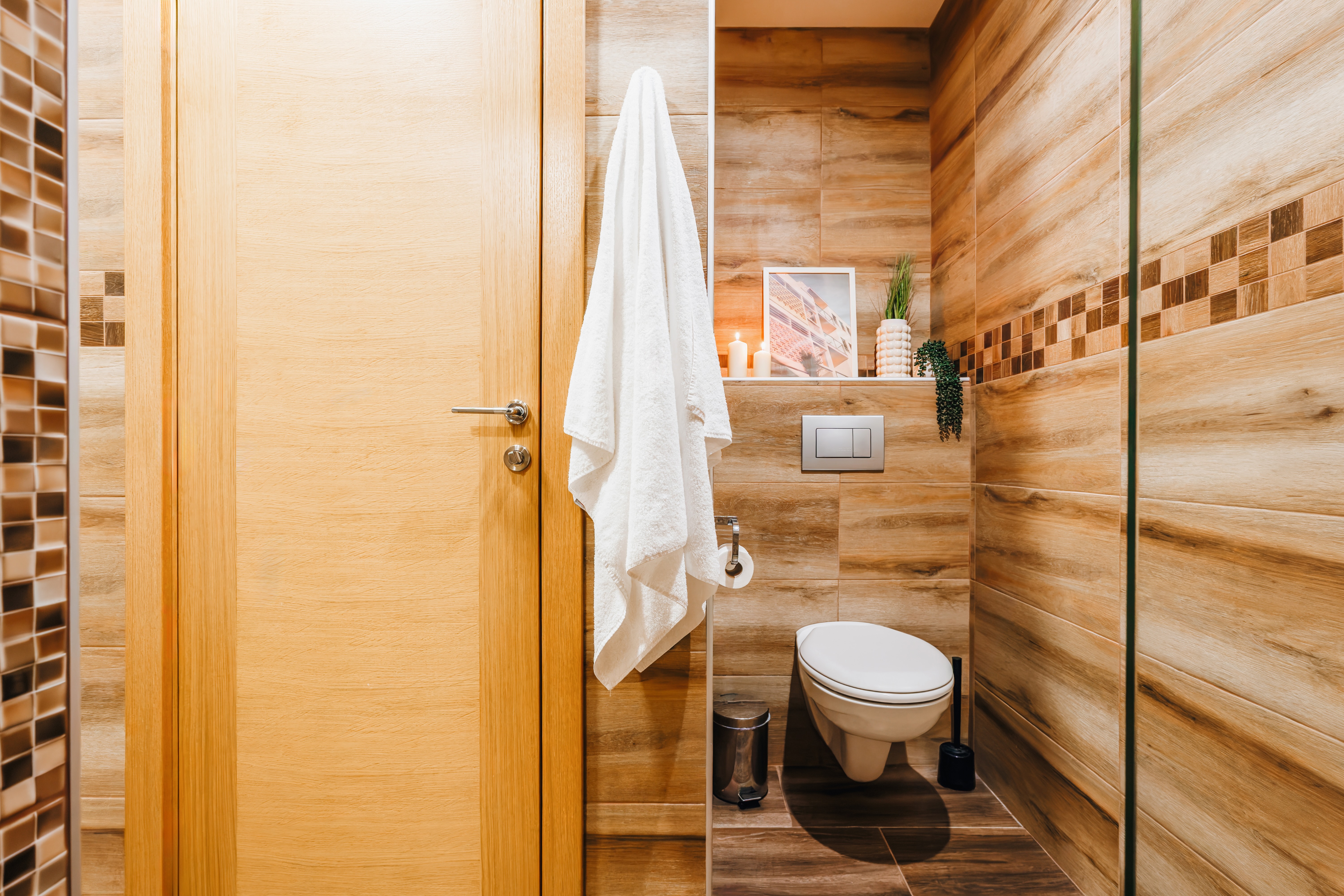 Modern spa-style bathroom with warm wood finishes and sleek design
