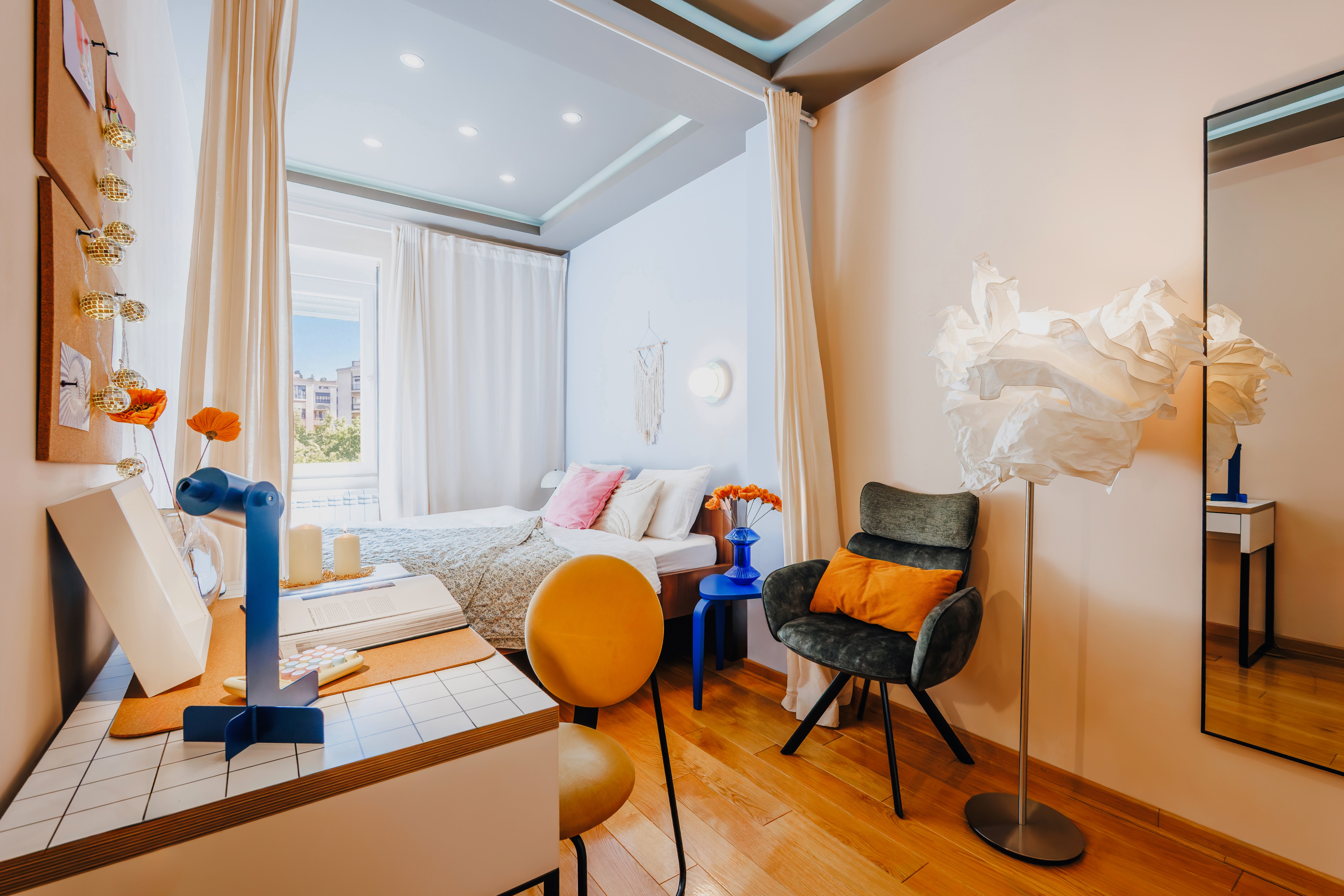 Bright designer bedroom with canopy bed, workspace, and chic modern accents
