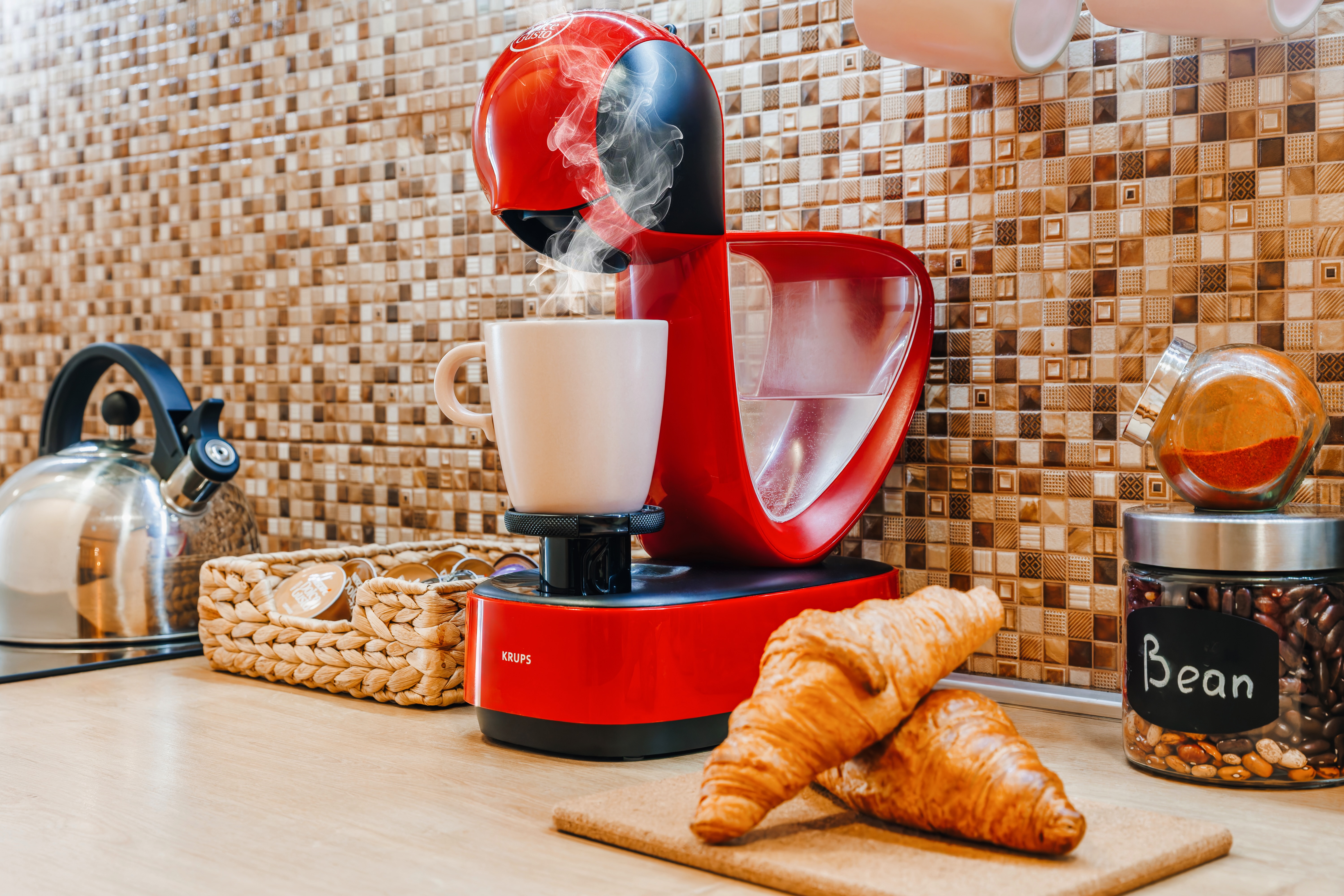 Inviting coffee station with espresso maker and fresh croissants