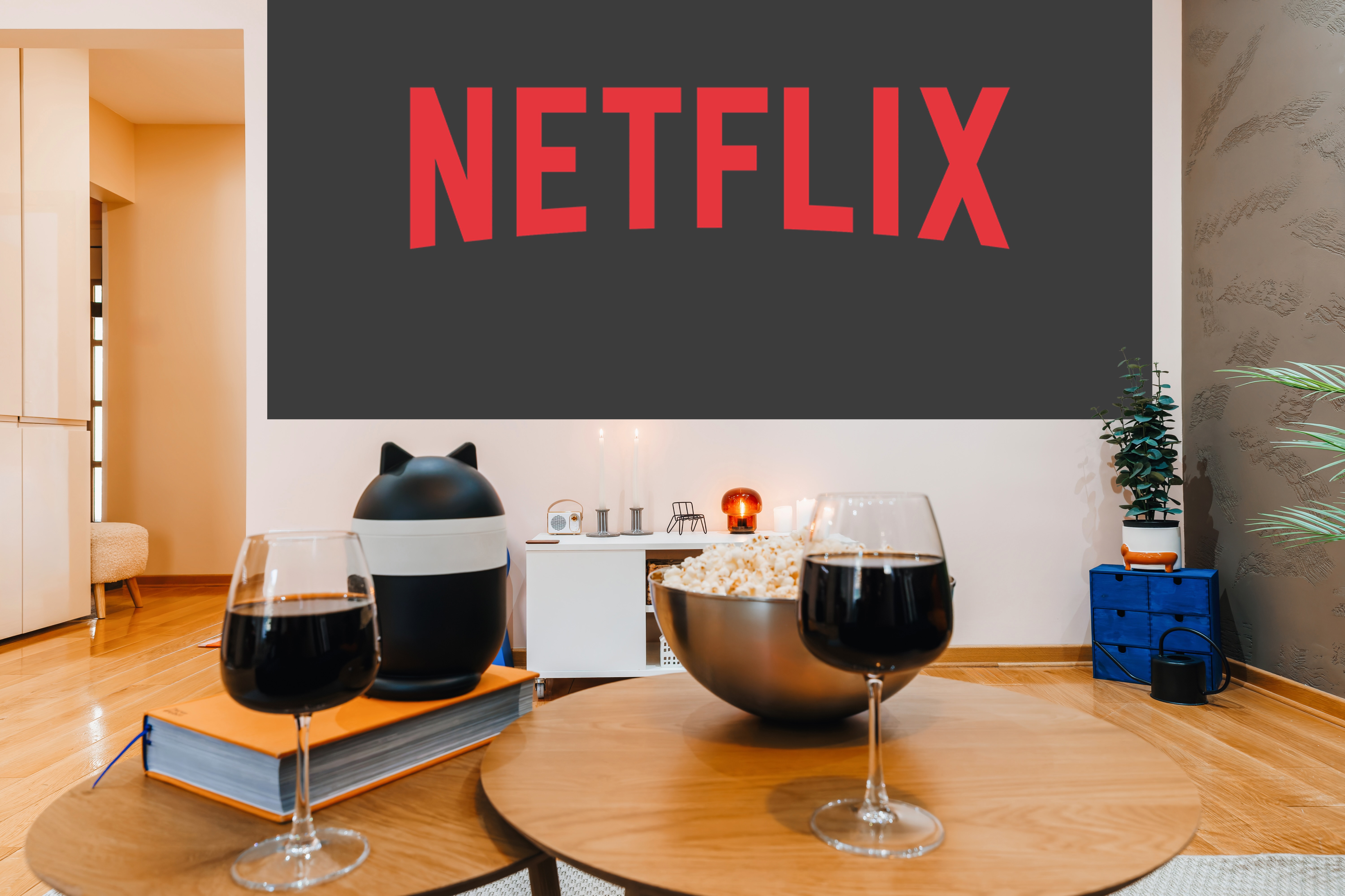 Cozy Netflix night setup with wine, popcorn, and modern lounge vibes