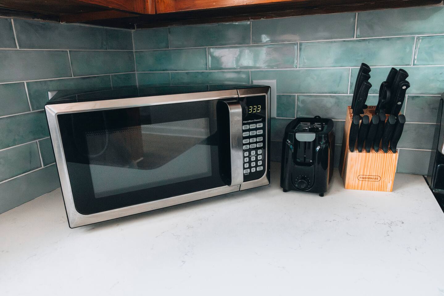 Microwave, toaster and knife block set along the counter