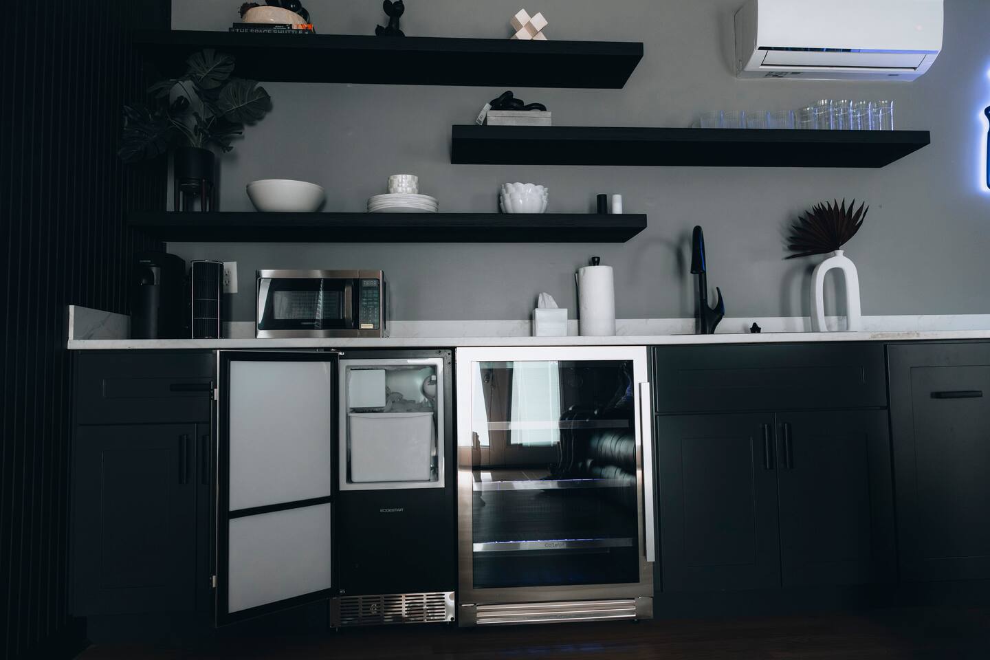 Wet bar close up with ice maker, beverage fridge and microwave