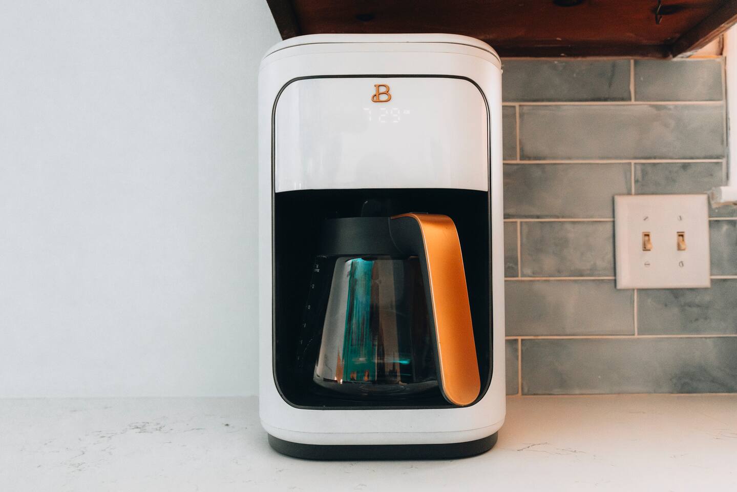 Drip coffee maker with glass carafe on the stone counter