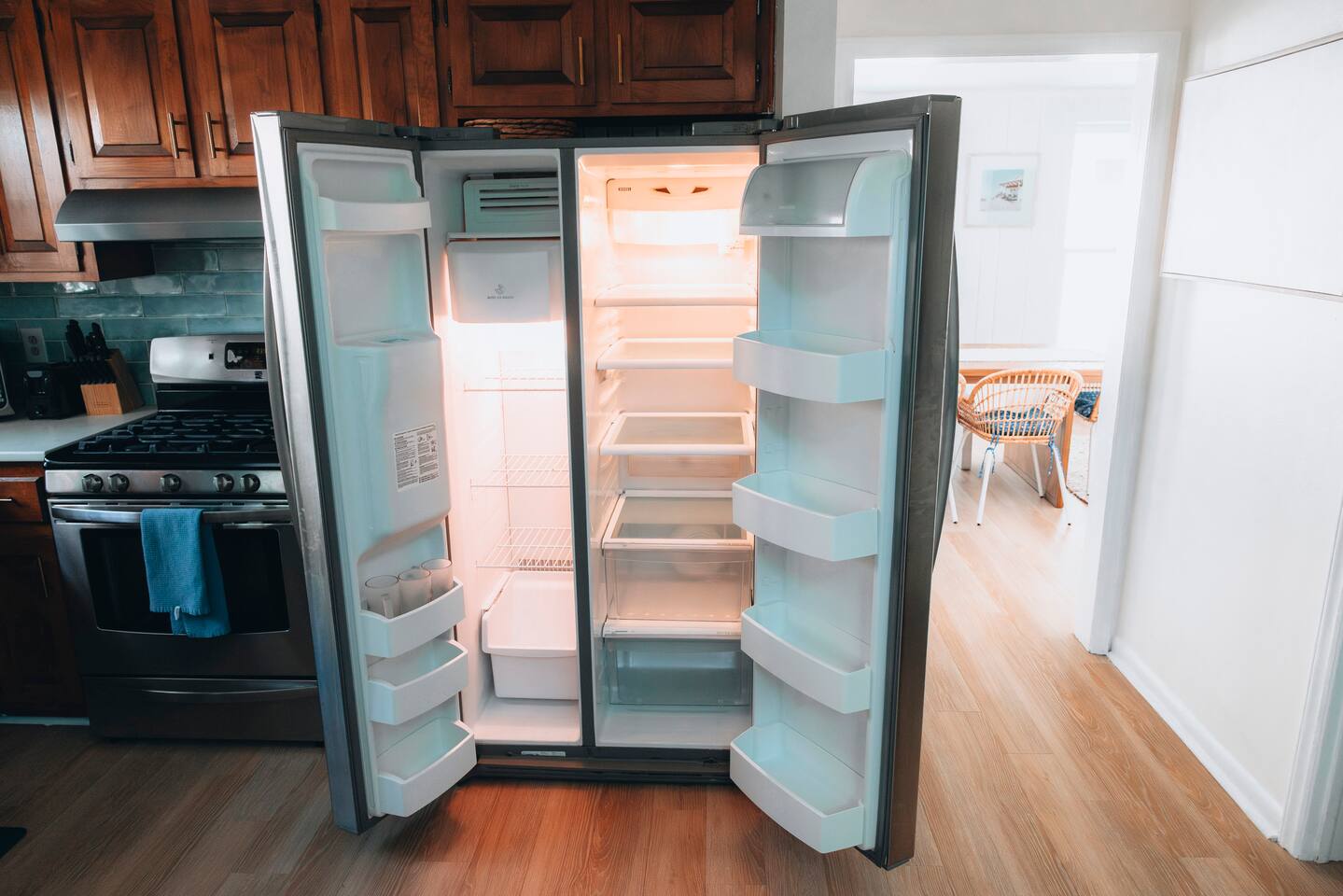 Side-by-side refrigerator opens to the dining room beyond