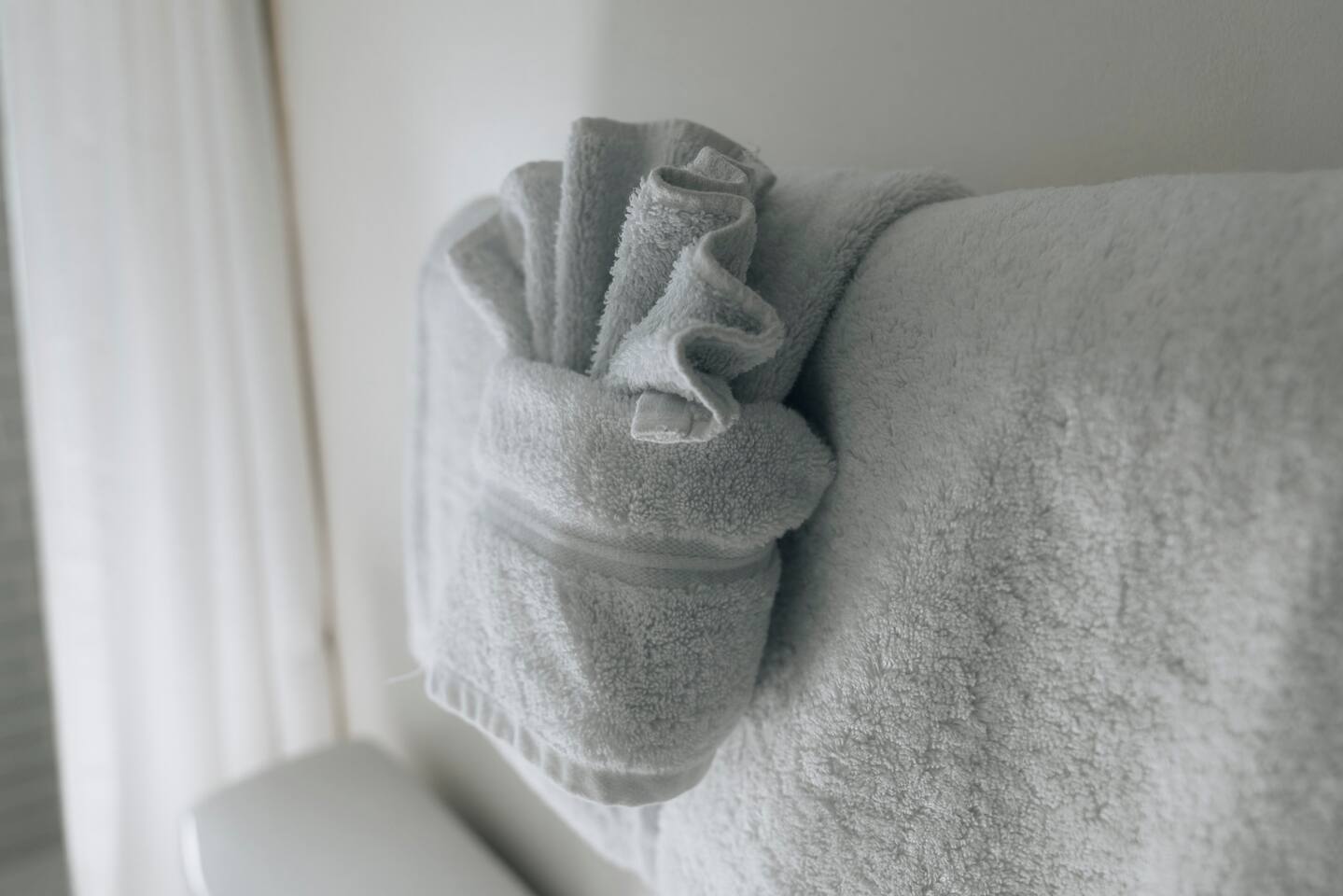 Fresh towels folded on the rail, ready for arrival