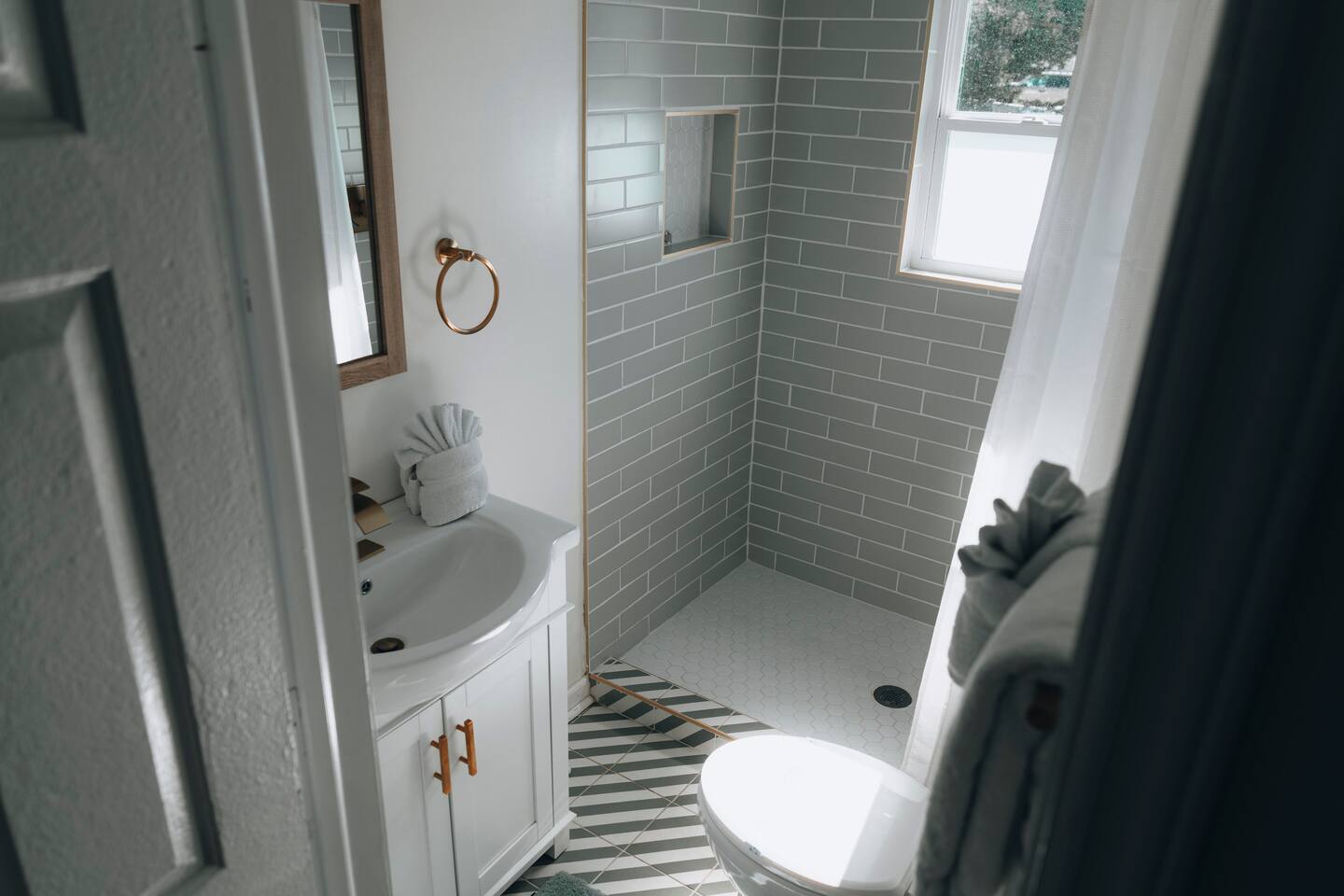 Bathroom with walk-in tiled shower, toilet and white vanity