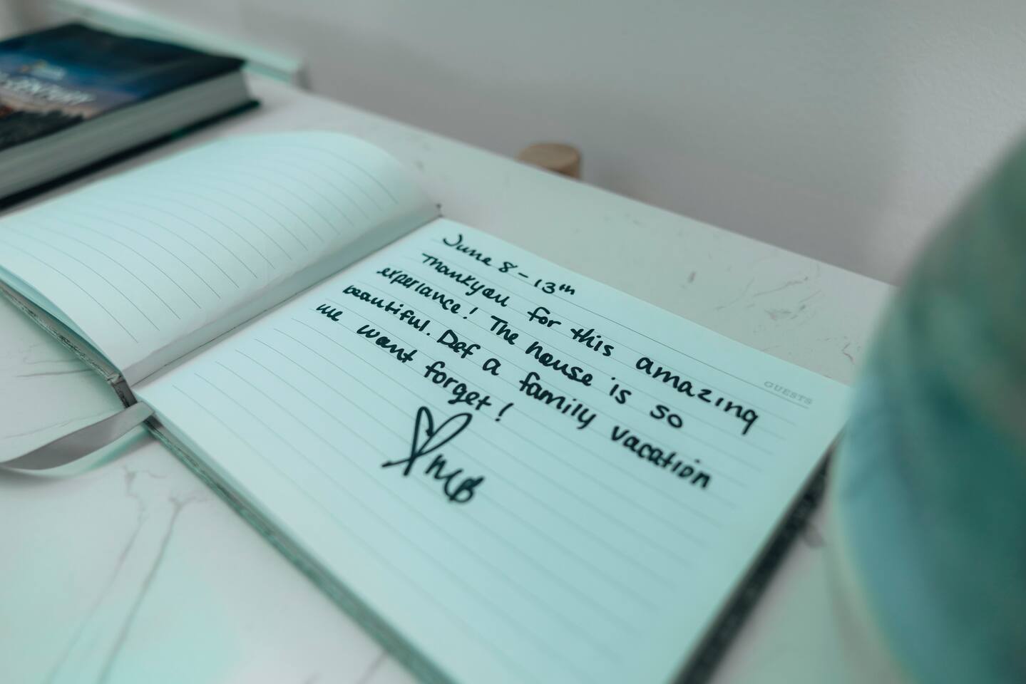 The guest book, open to a handwritten note from past visitors