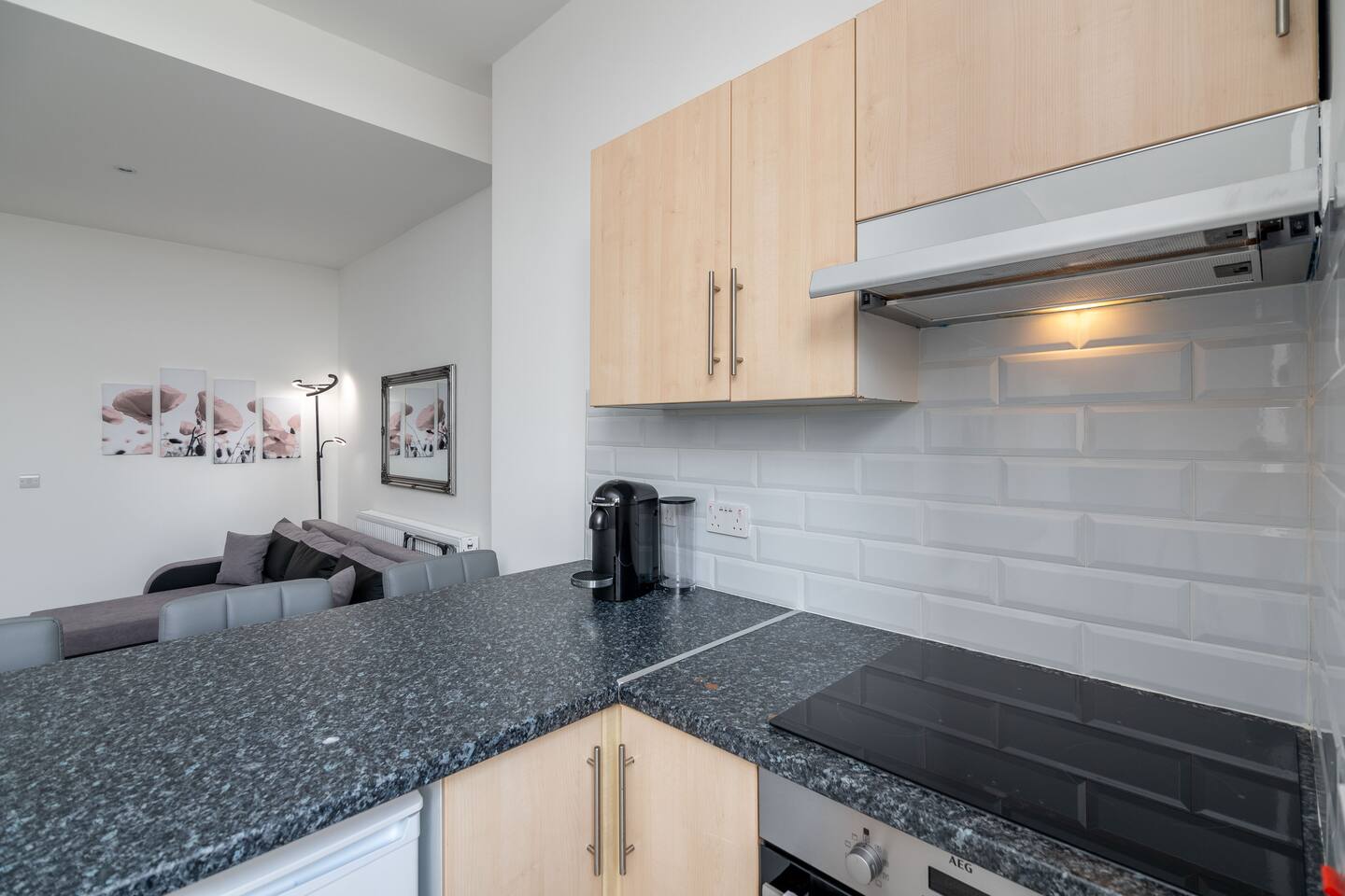 Cozy kitchen space with breakfast bar and washer.