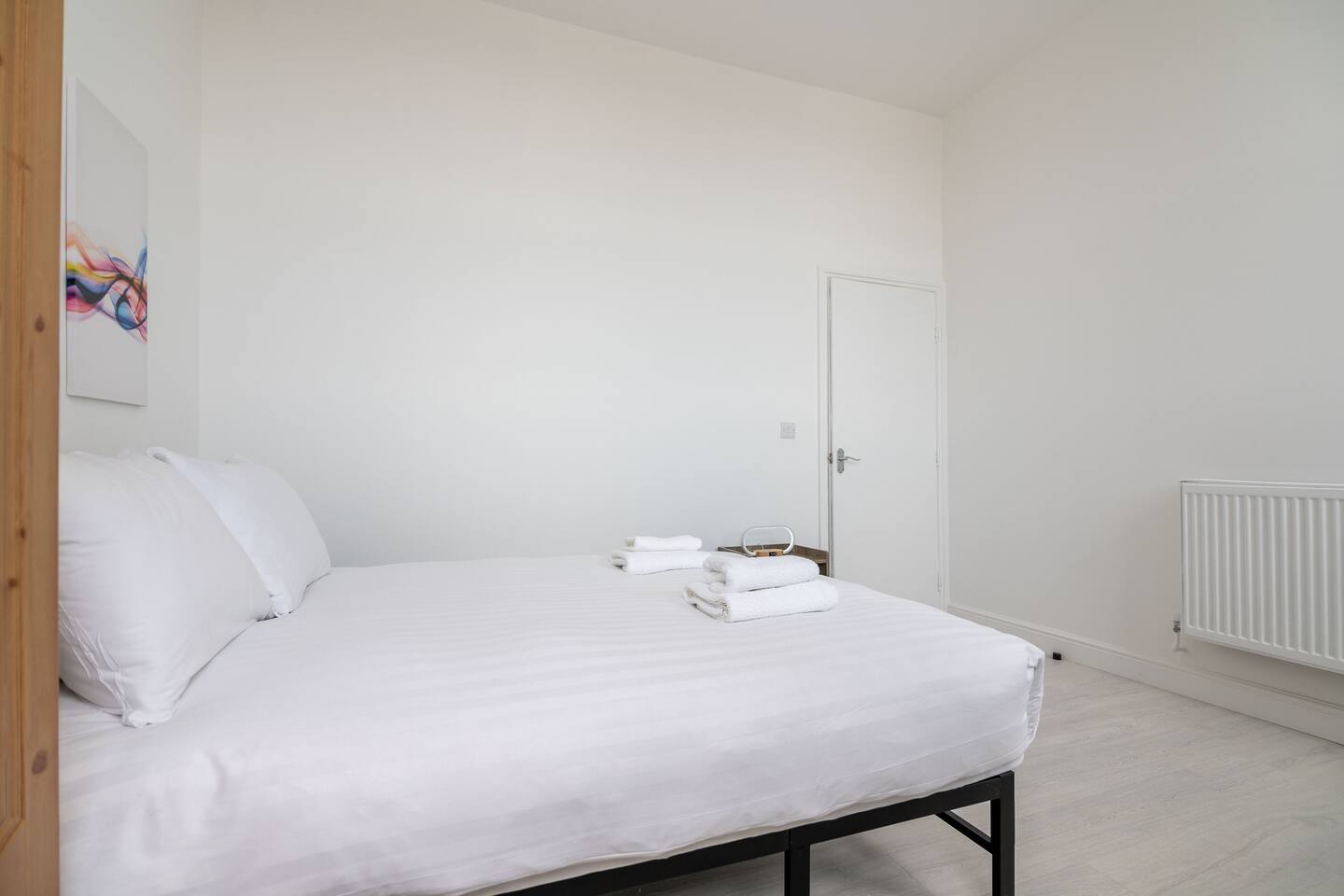 This home on Uxbridge Road, Greater London, minutes from Westfield London, features a cozy bedroom with a comfy bed, soft lighting, and relaxing vibes, ideal for rest after a long day.